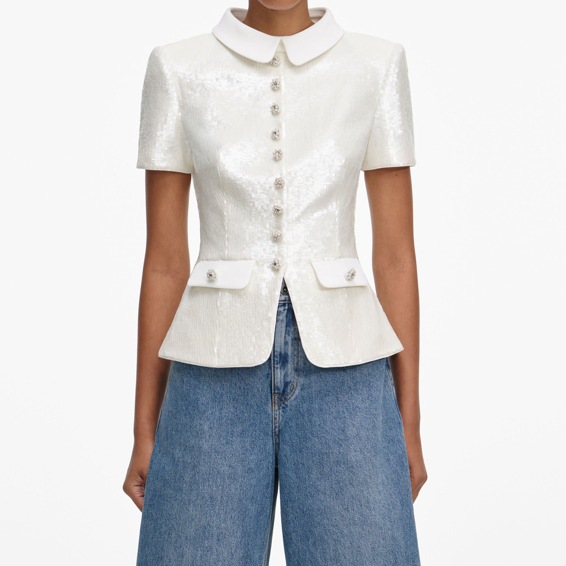 A close up of a woman wearing the White Sequin Tailored Top
