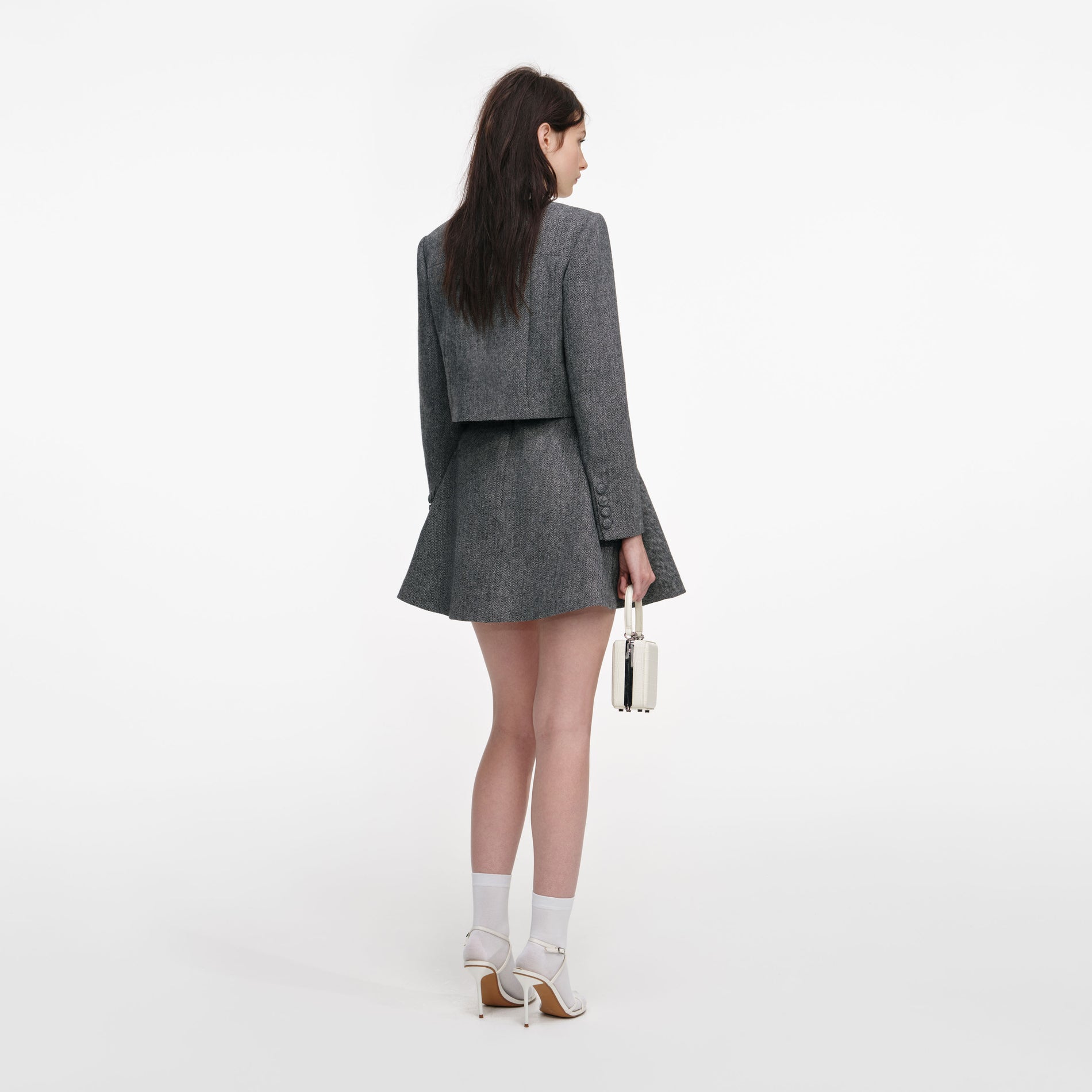 Back view of a woman wearing the Grey Herringbone Scarf Detail Jacket