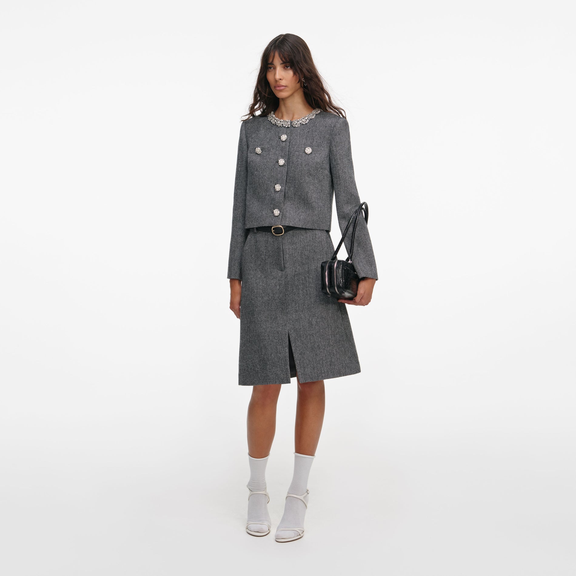 Side view of a woman wearing the Grey Herringbone Crystal Trim Jacket