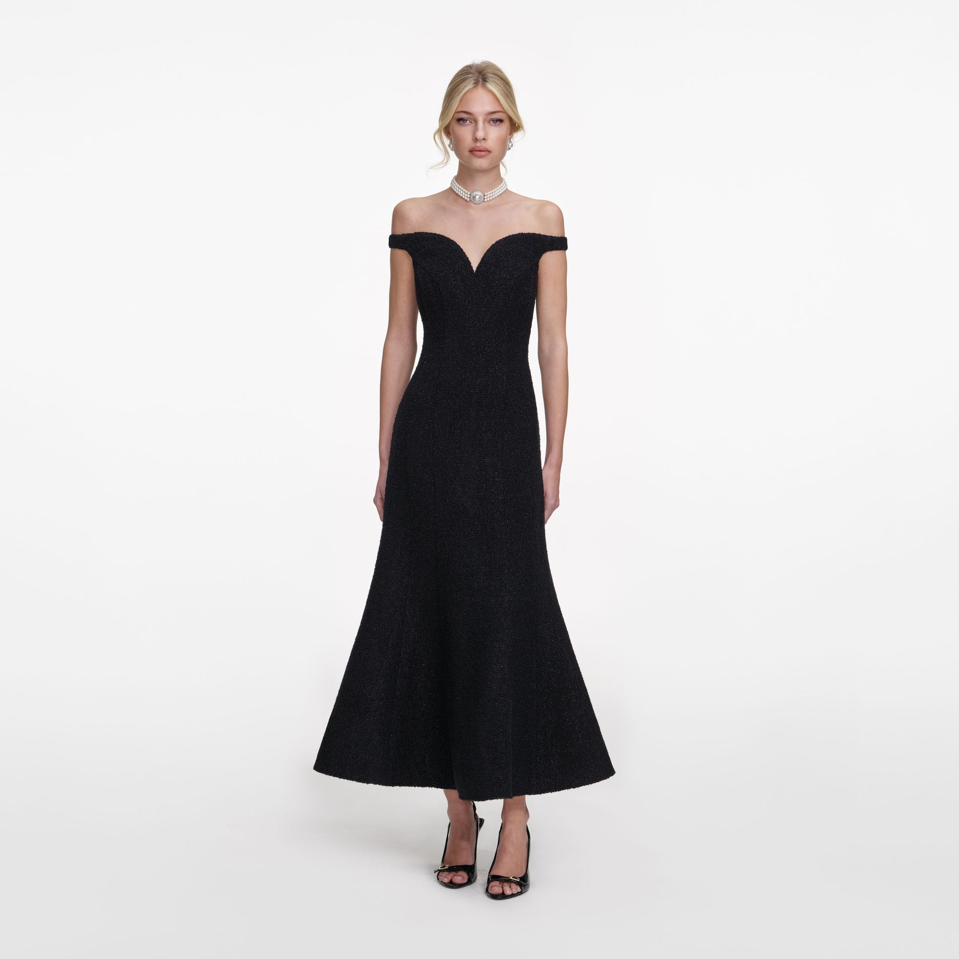 Front view of a woman wearing the Black Boucle Midi Dress