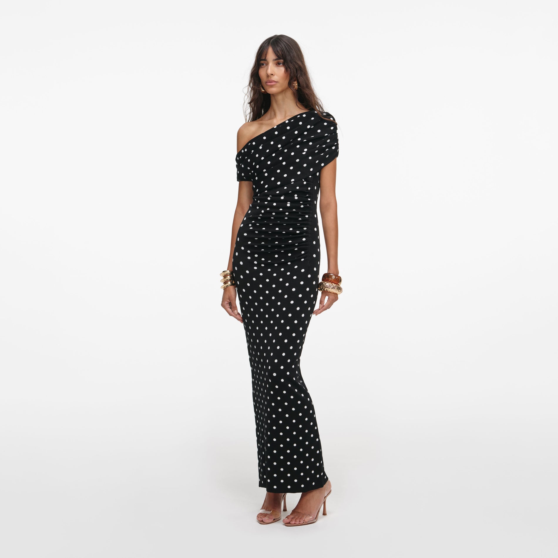 Side view of a woman wearing the Polka Dot Draped Knit Midi Dress