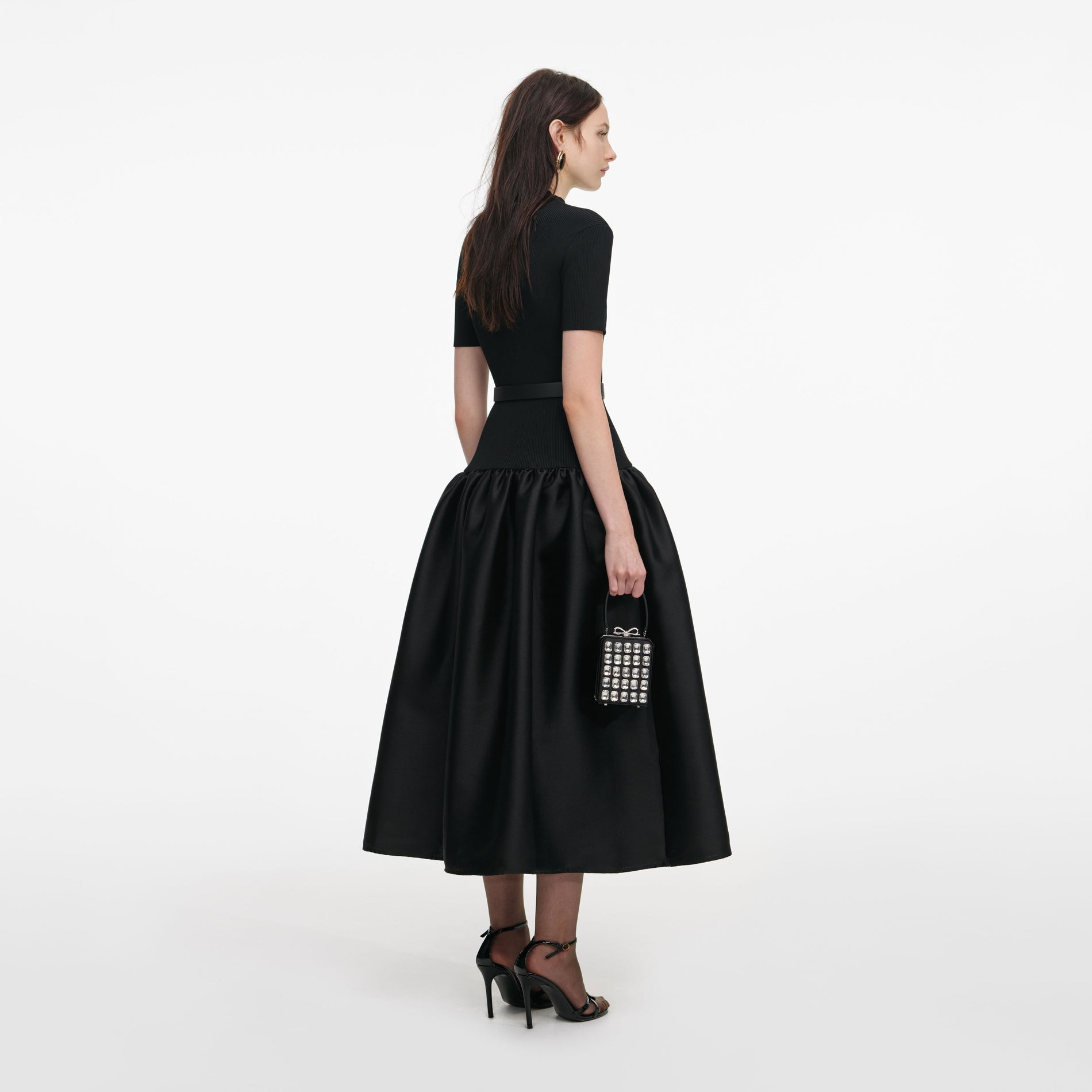 Back view of a woman wearing the Black Knit Taffeta Midi Dress