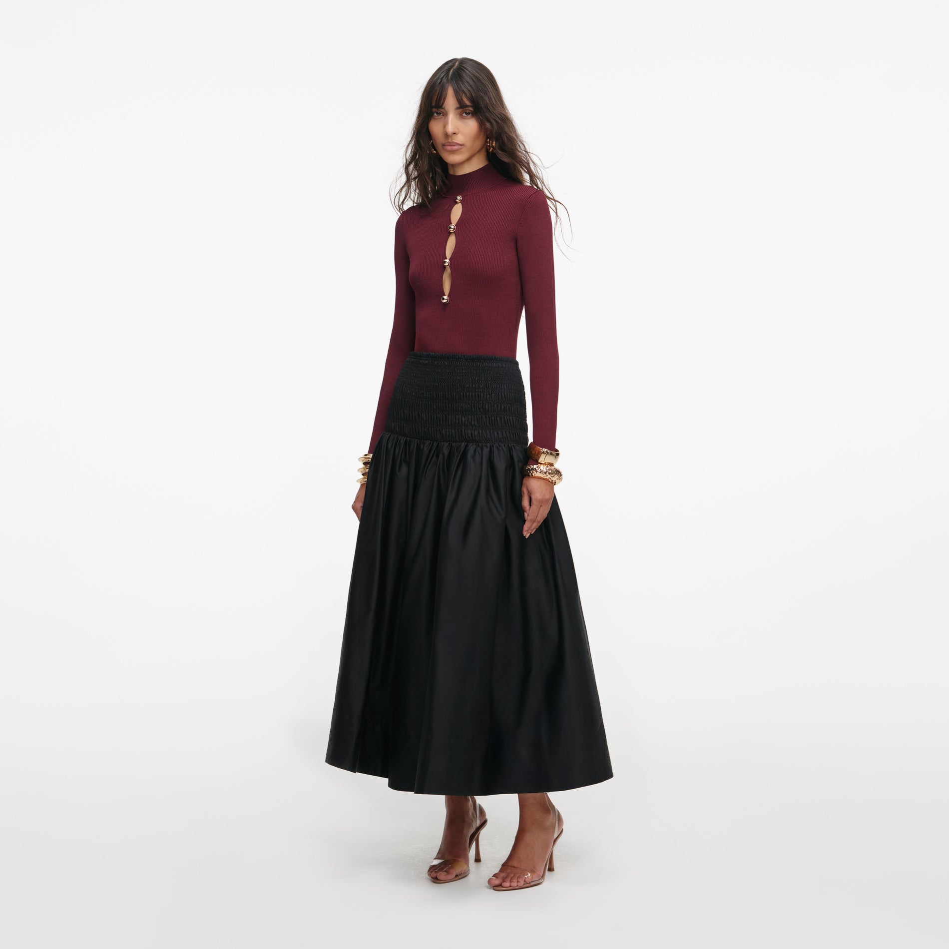 Side view of a woman wearing the Black Cotton Midi Skirt