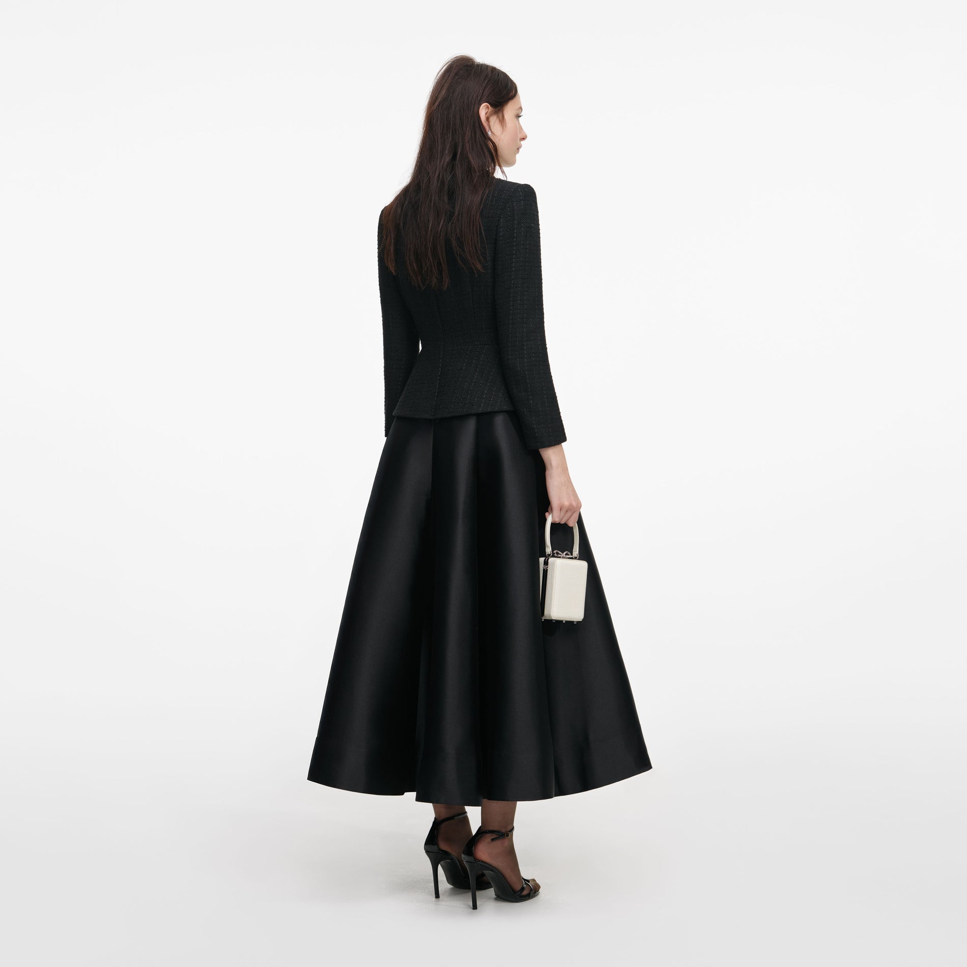 Back view of a woman wearing the Black Boucle Taffeta Midi Dress
