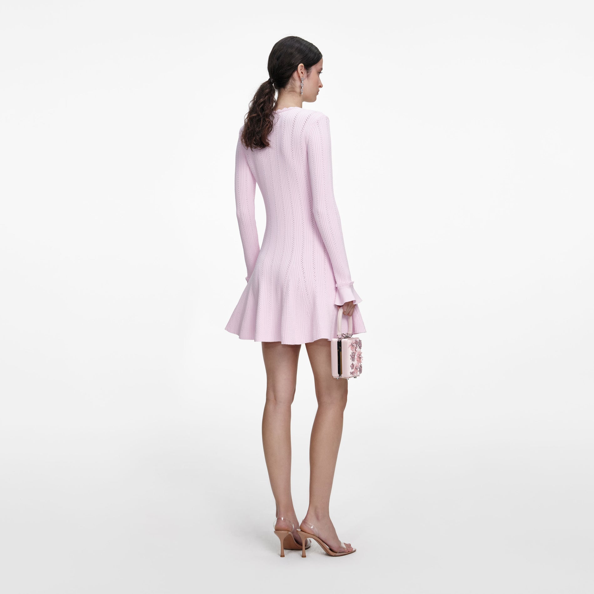 Back view of a woman wearing the Pink Pearl Trim Knit Mini Dress