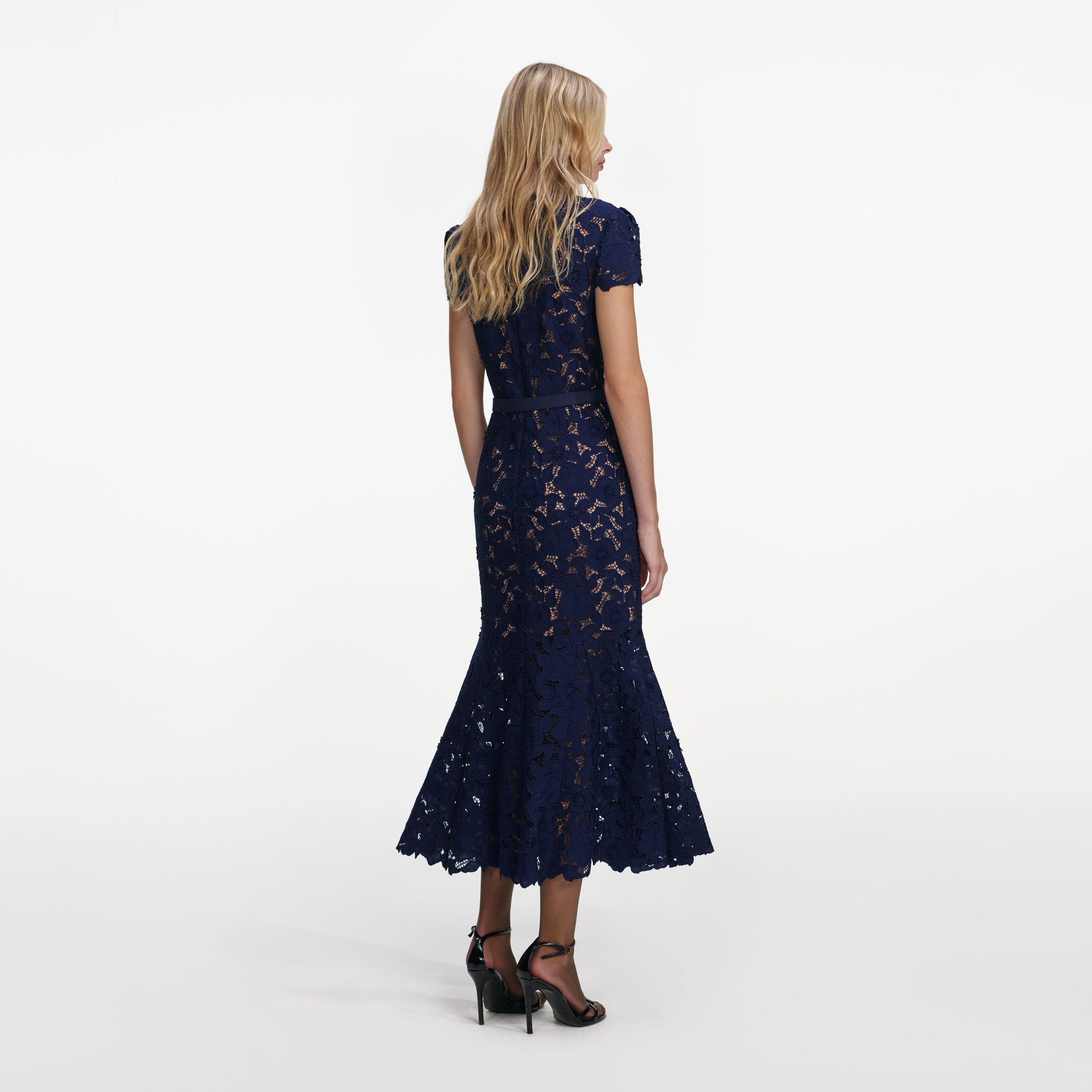 Back view of a woman wearing the Navy Guipure Lace Midi Dress