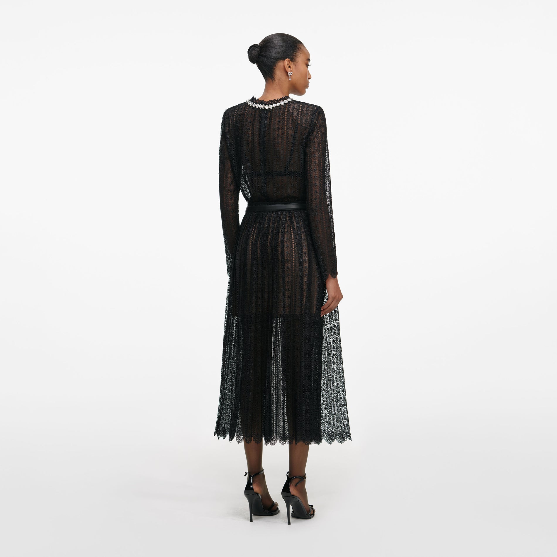 Back view of a woman wearing the Black Organza Lace Midi Skirt