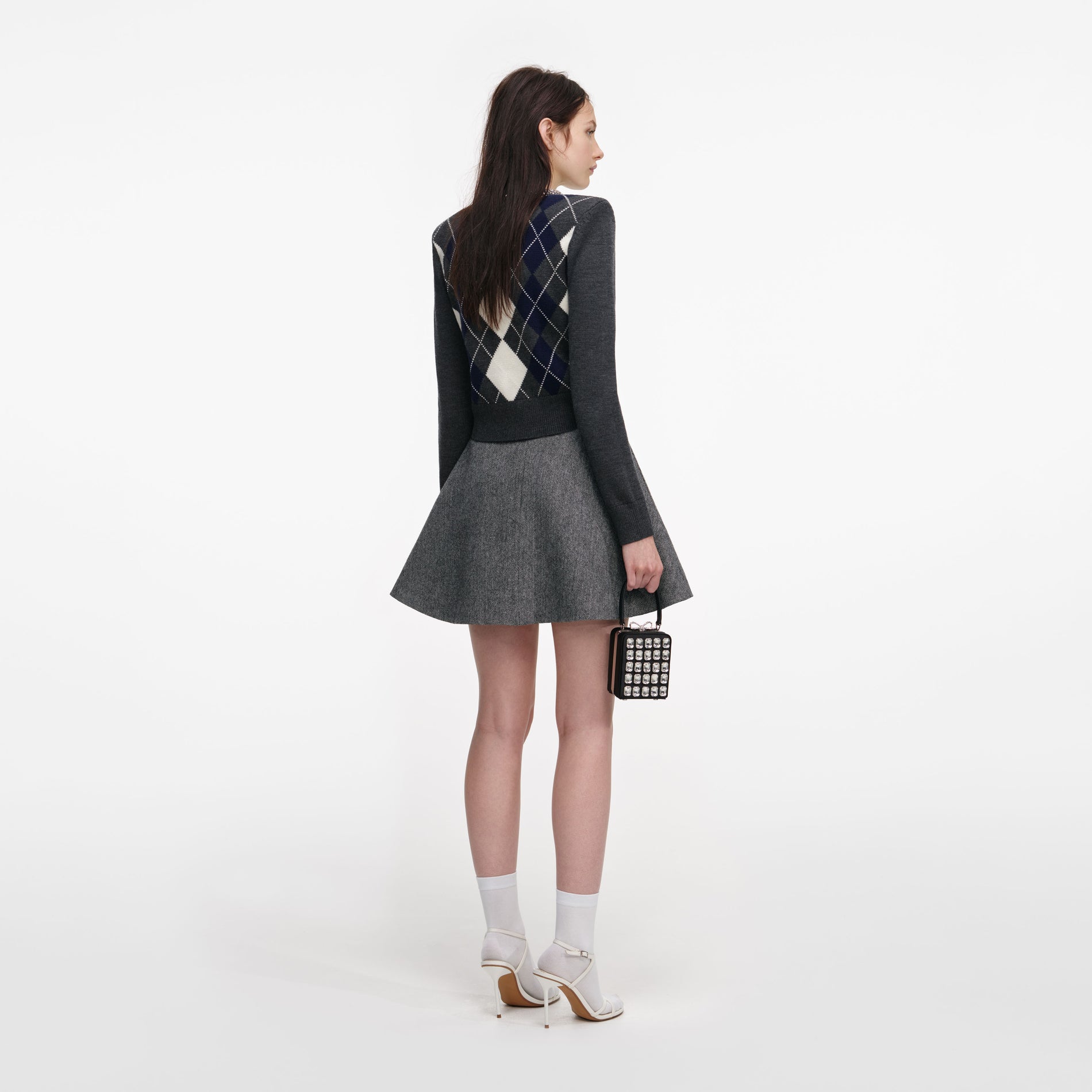 Back view of a woman wearing the Grey Argyle Crystal Trim Jumper