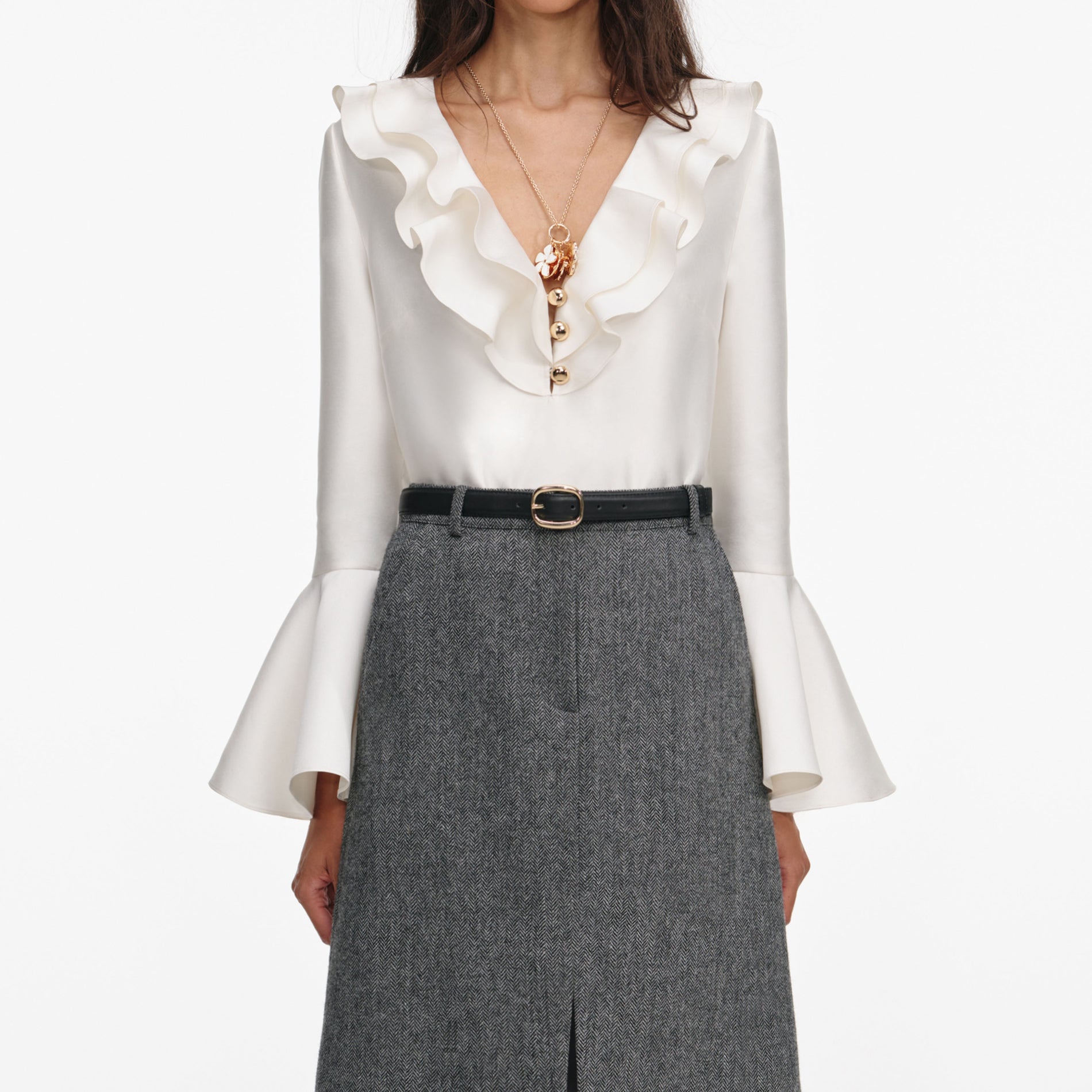 A close up of a woman wearing the Cream Taffeta Ruffle Top