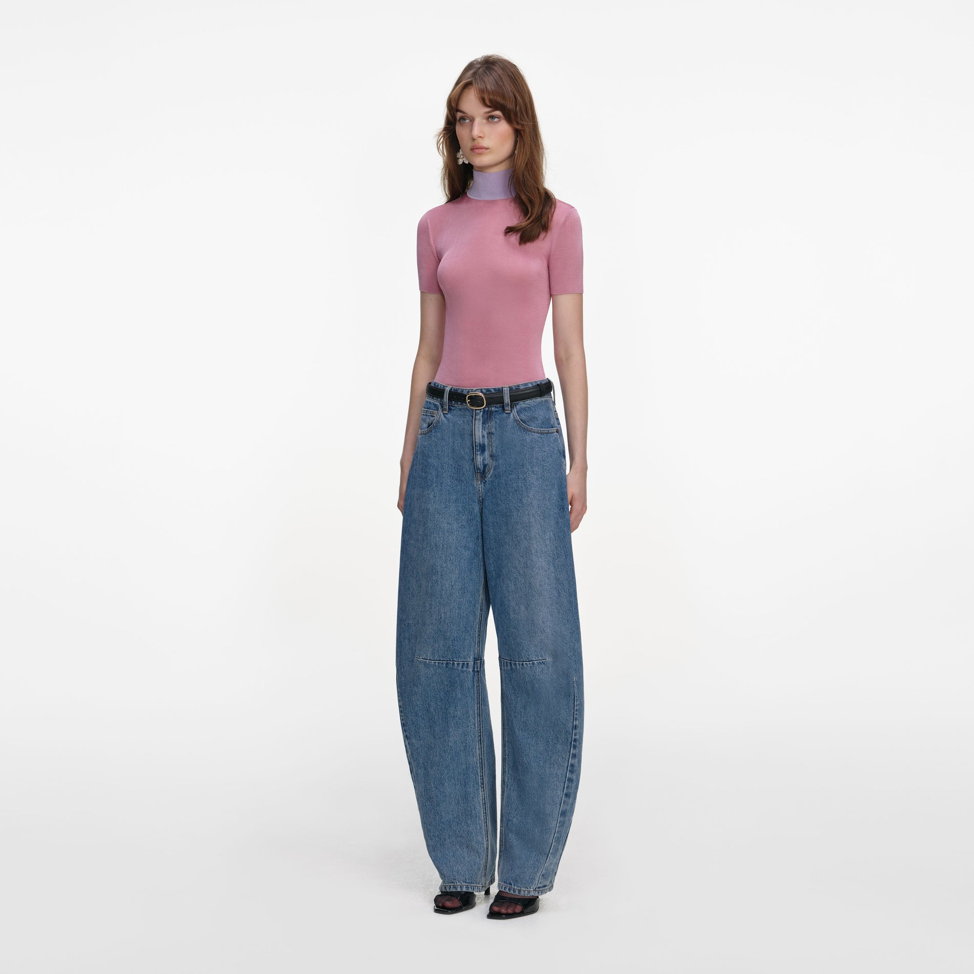 Side view of a woman wearing the Pink Short Sleeve Viscose Knit Top