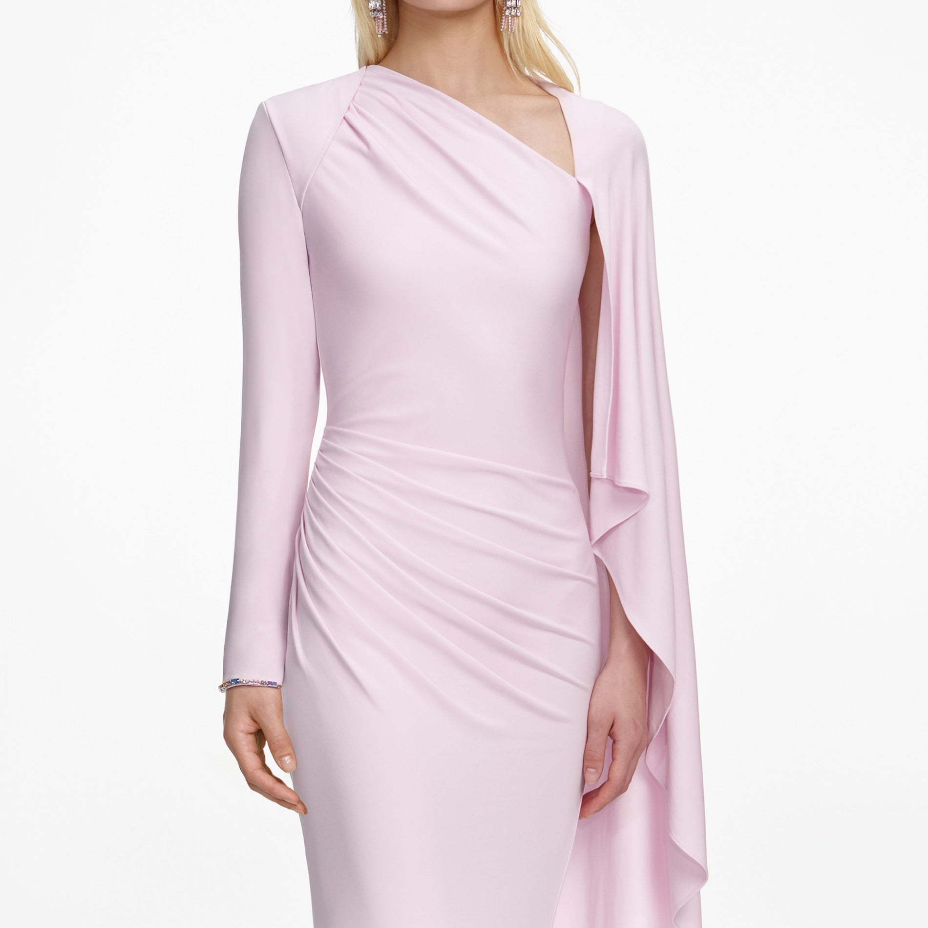 A close up of a woman wearing the Pink Jersey Drape Maxi Dress