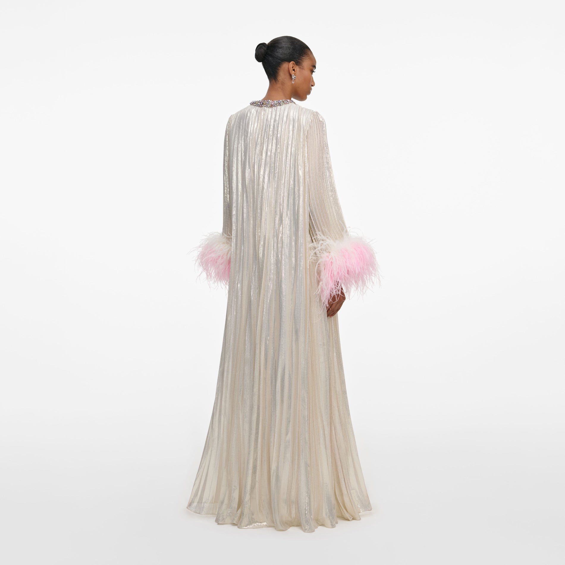 Back view of a woman wearing the Champagne Metallic Ombre Feather Maxi Dress
