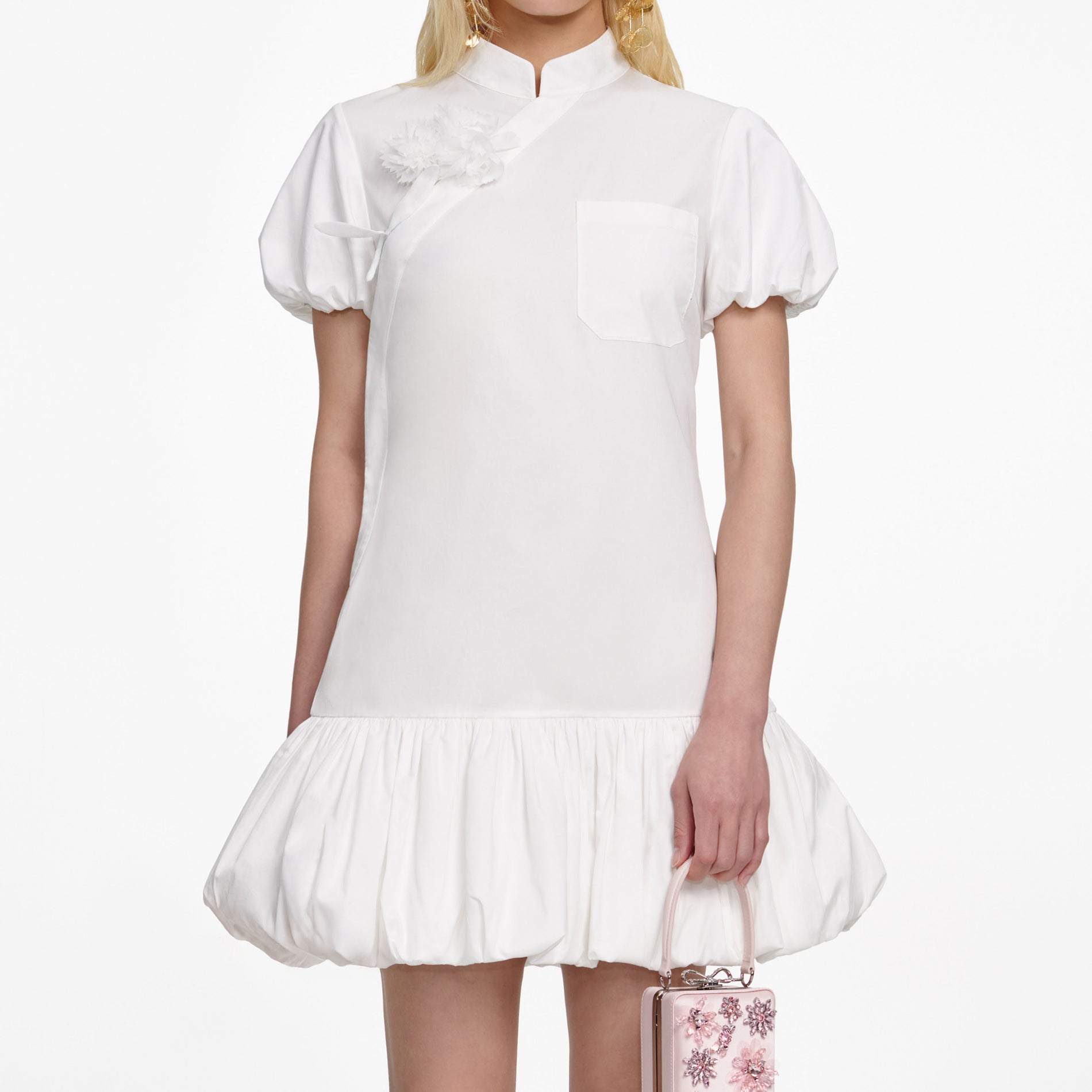 A close up of a woman wearing the White Cotton Asymmetric Mini Dress