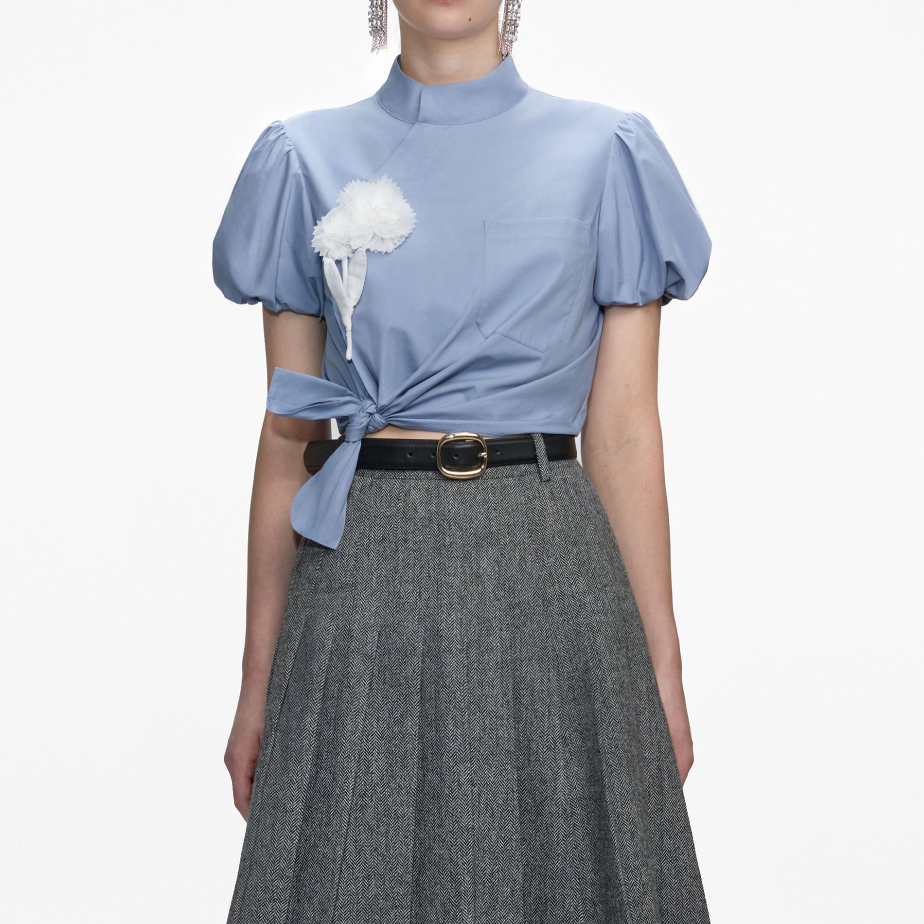 A close up of a woman wearing the Blue Cotton Tie Side Top