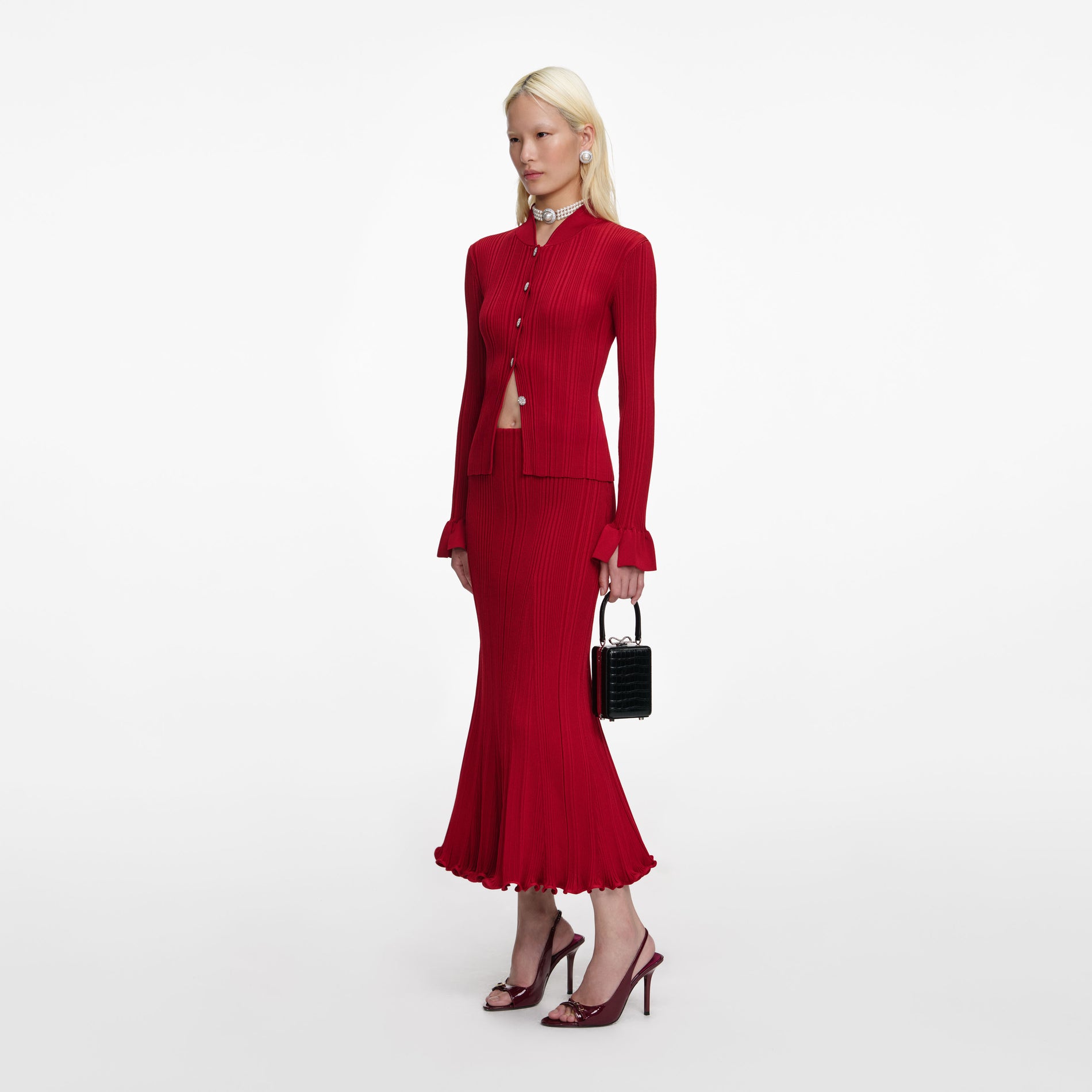 Side view of a woman wearing the Red Viscose Knit Midi Skirt