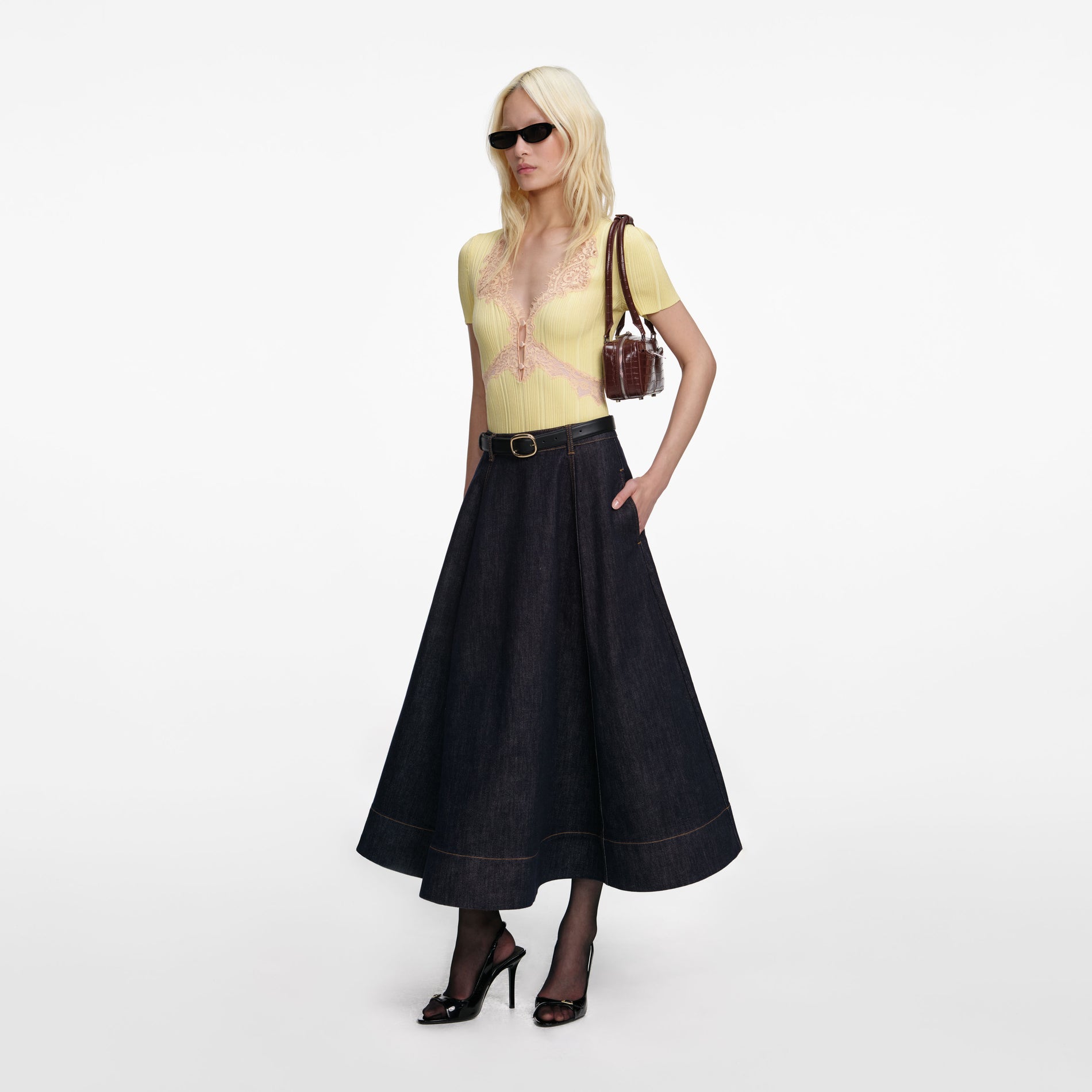 Side view of a woman wearing the Indigo Denim Flared Midi Skirt