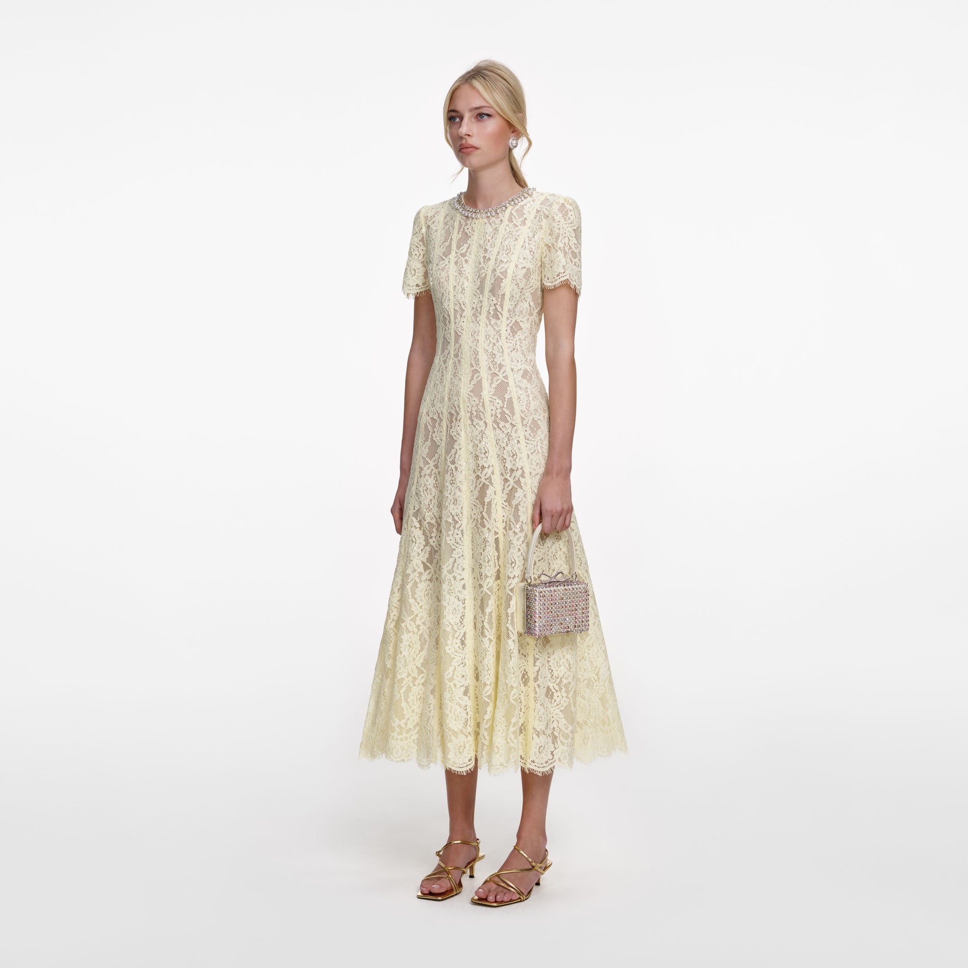 Side view of a woman wearing the Yellow Lace Embellished Midi Dress