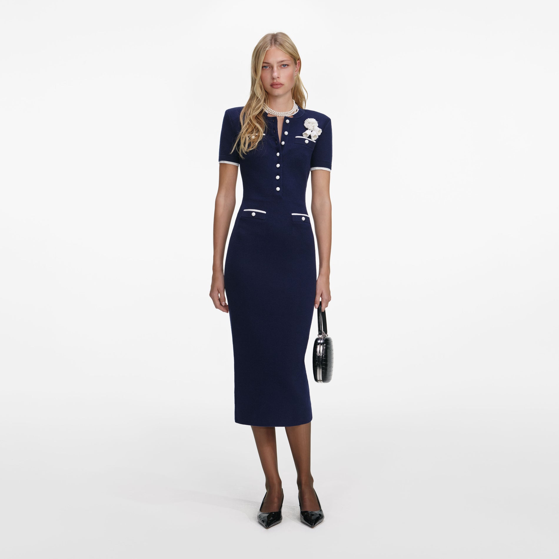 Front view of a woman wearing the Navy Crochet Flower Knit Midi Dress