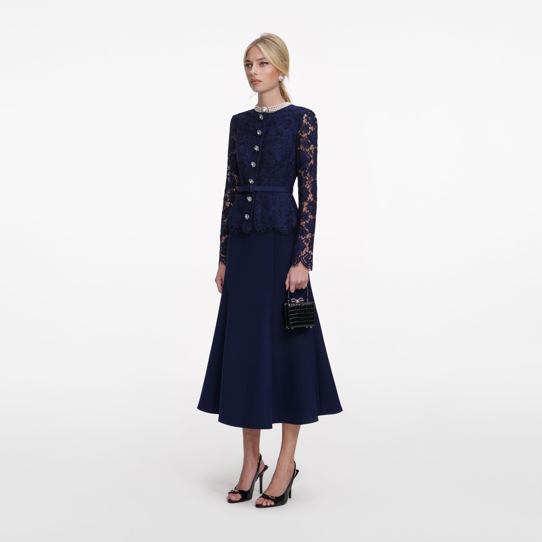 Side view of a woman wearing the Navy Tailored Lace Midi Dress