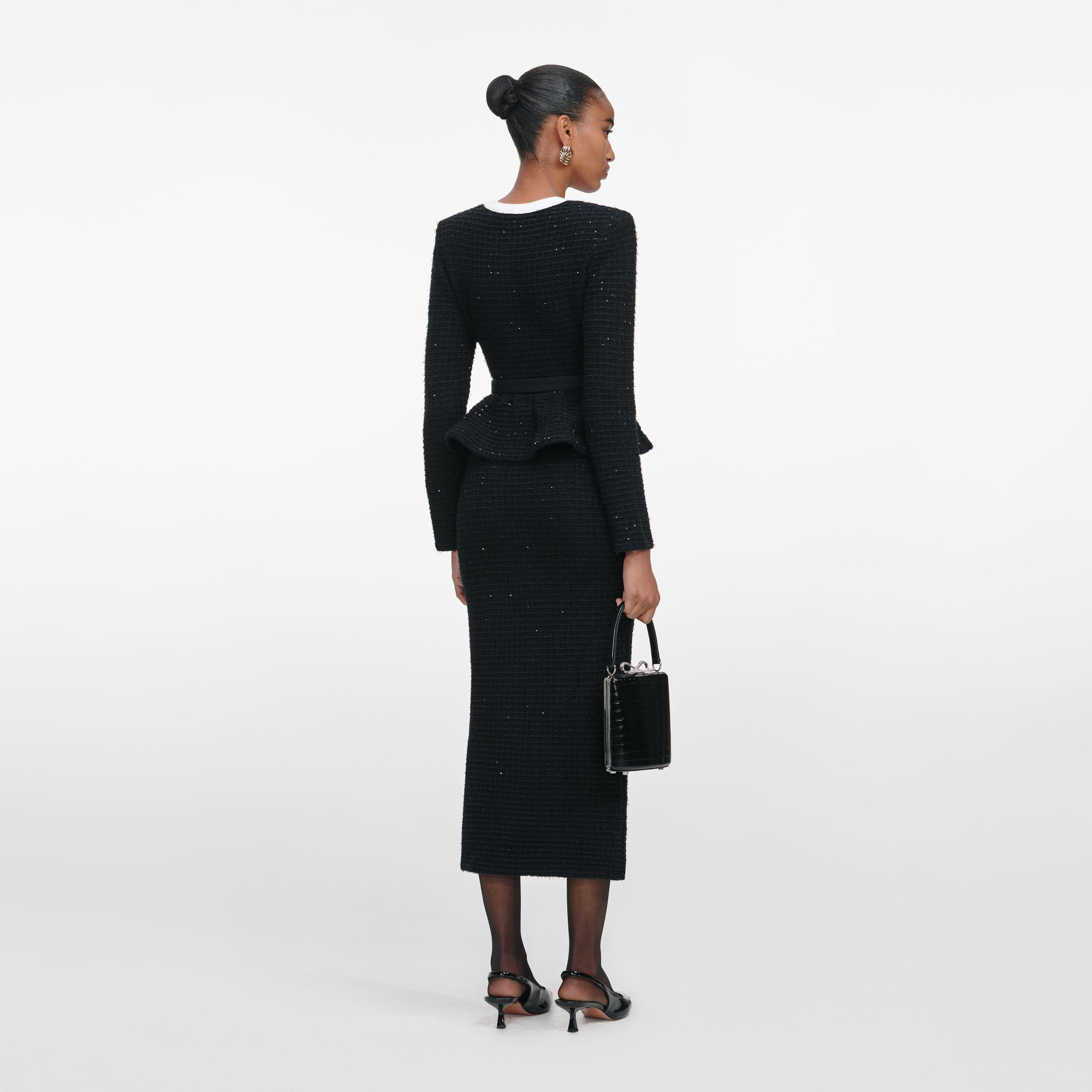 Back view of a woman wearing the Black Floral Textured Knit Midi Dress
