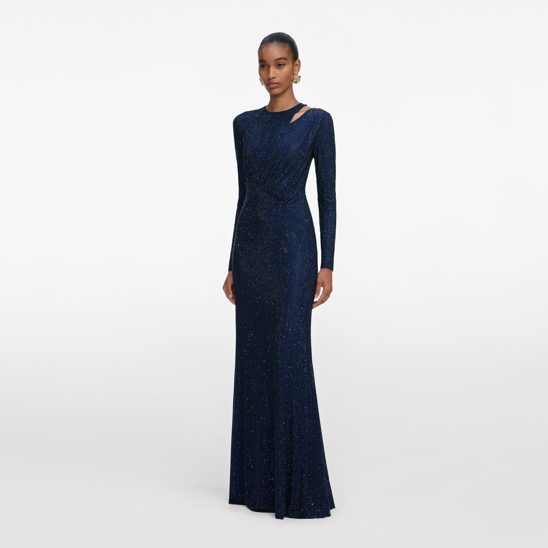 Side view of a woman wearing the Navy Rhinestone Mesh Cut Out Maxi Dress