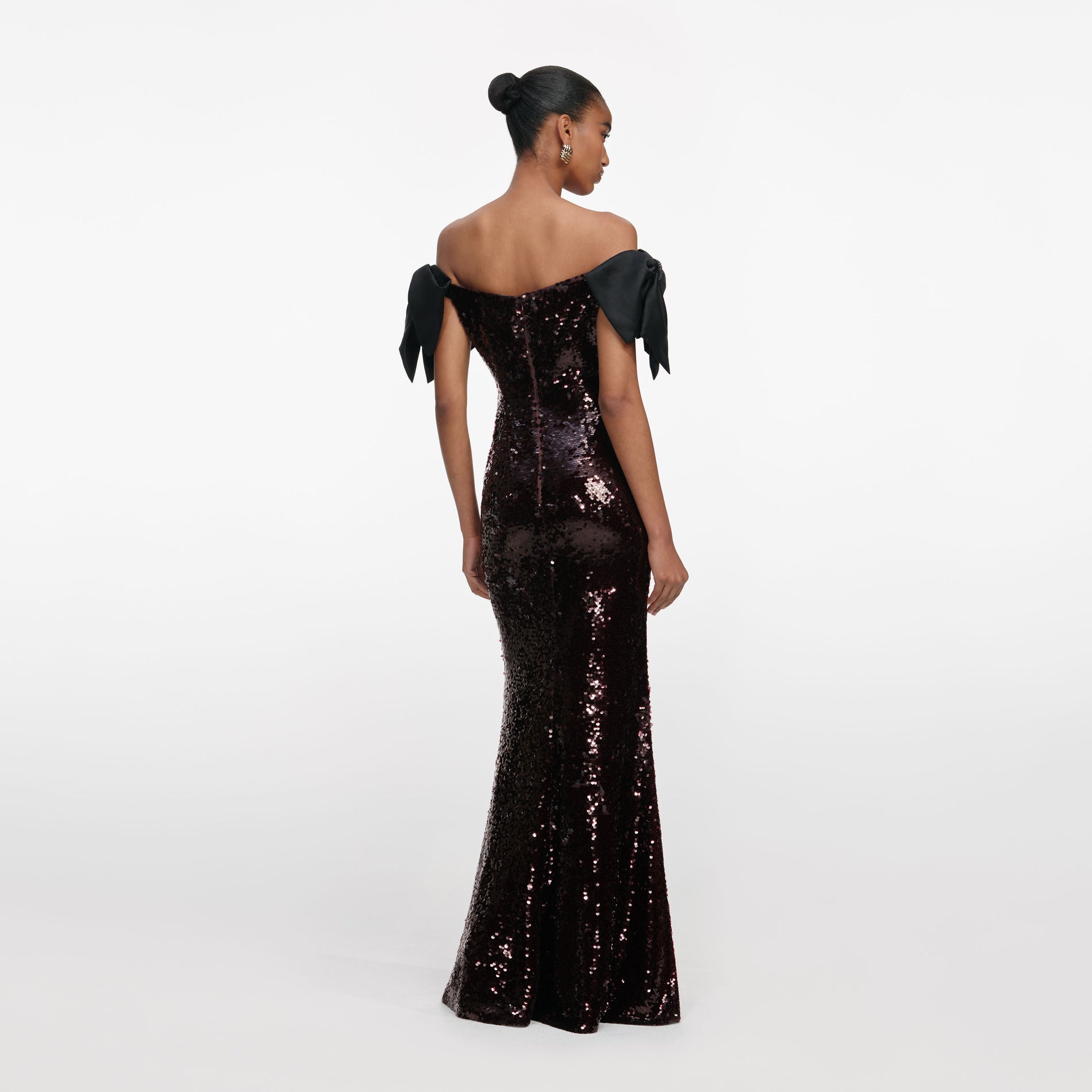 Back view of a woman wearing the Brown Sequin Bow Maxi Dress