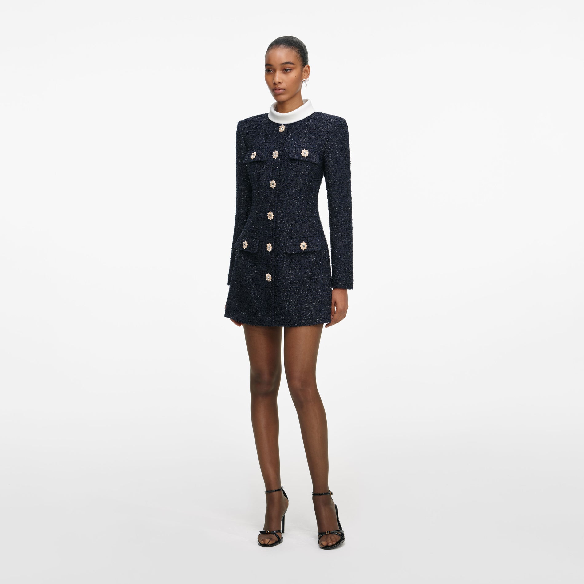 Side view of a woman wearing the Navy Boucle Long Sleeve Mini Dress