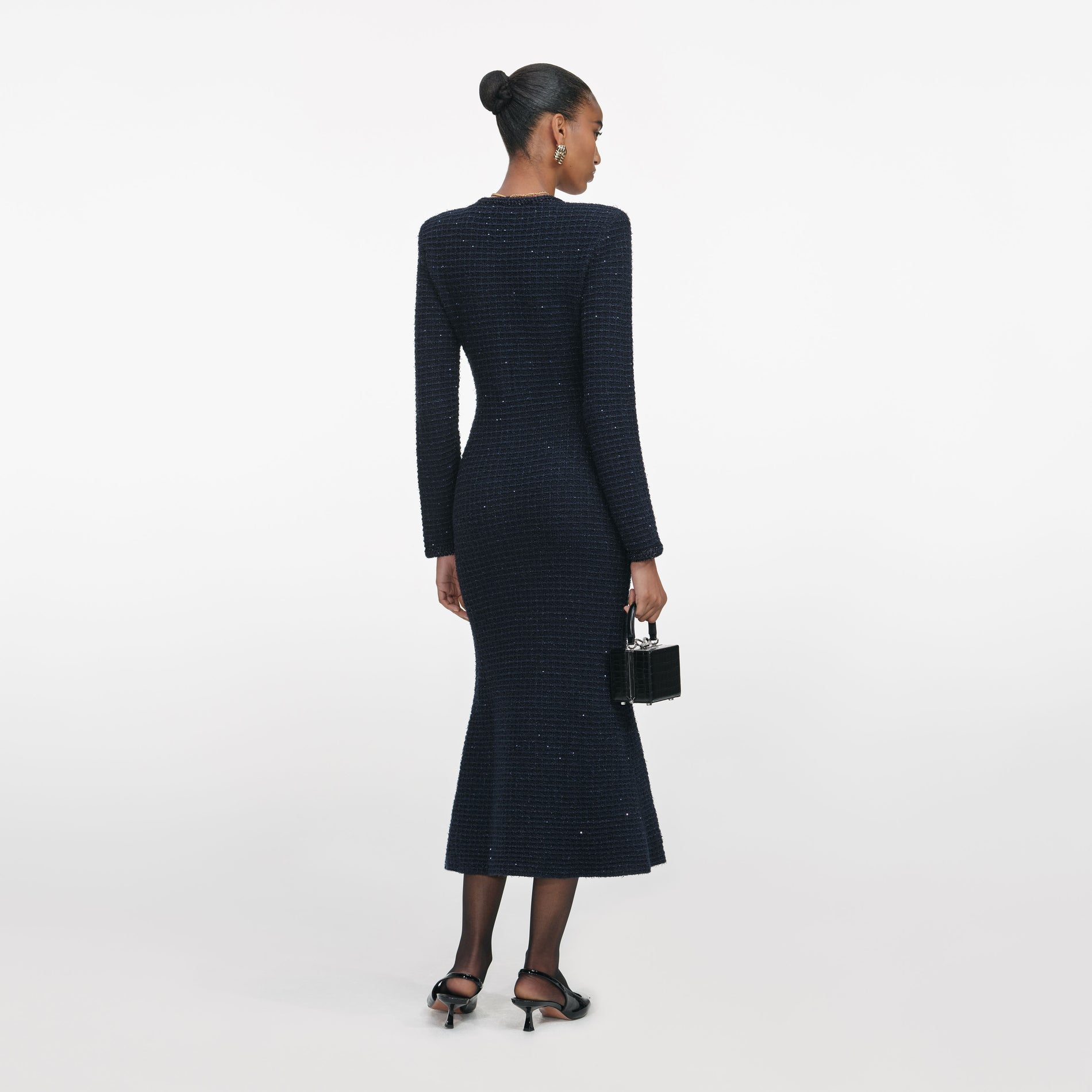 Back view of a woman wearing the Navy Textured Knit Midi Dress