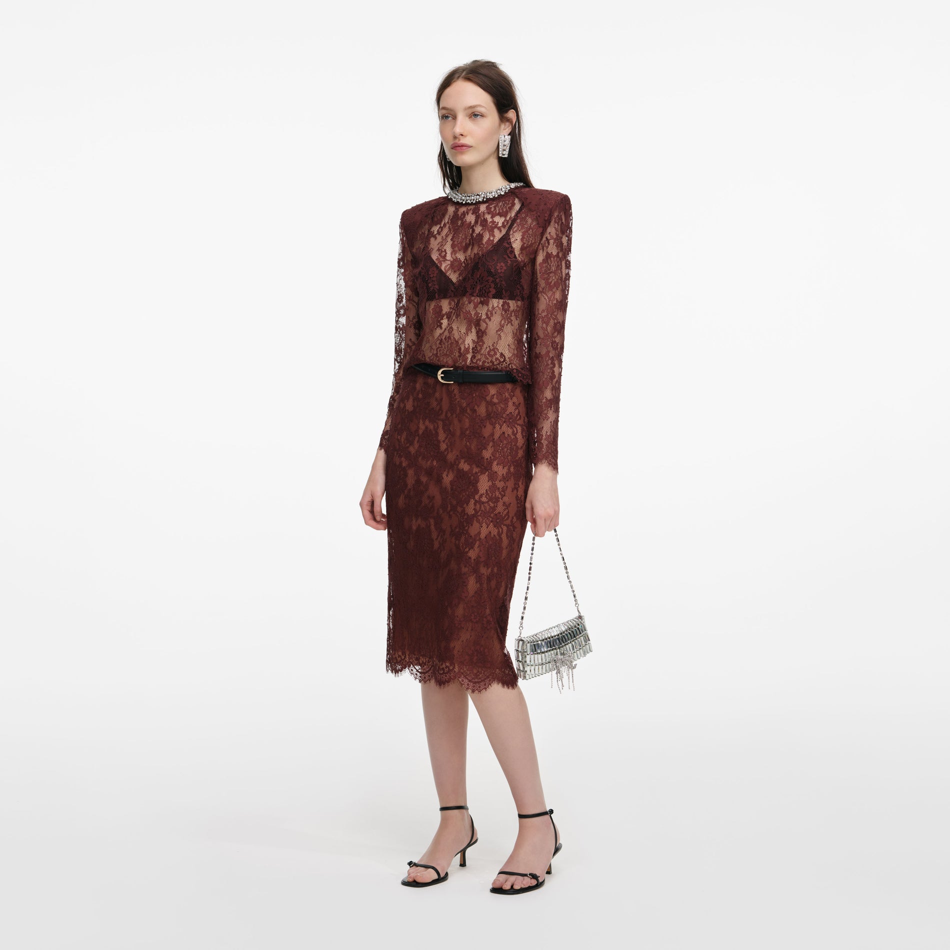 Side view of a woman wearing the Brown Floral Lace Midi Skirt