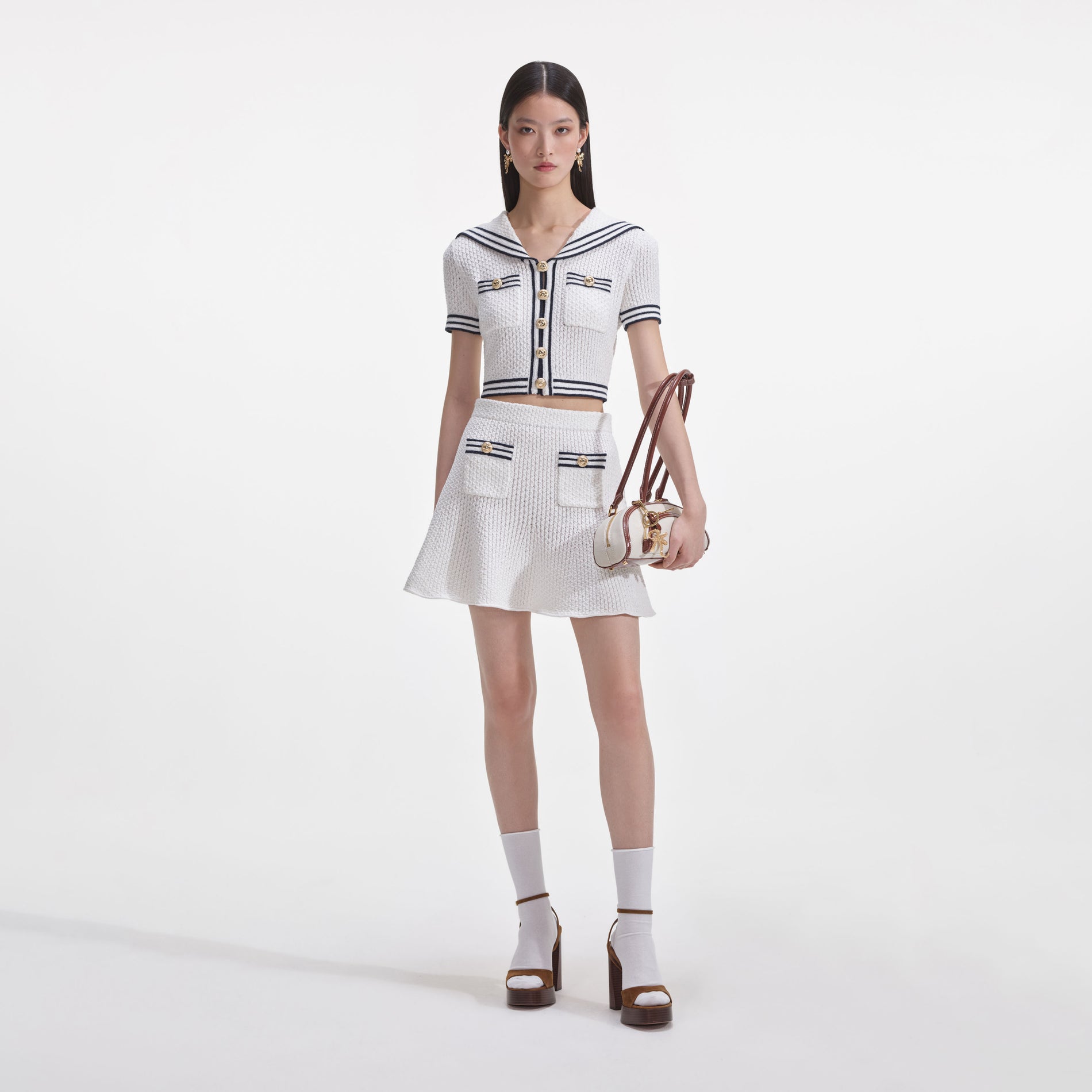 Front view of a woman wearing the White Textured Knit Mini Skirt