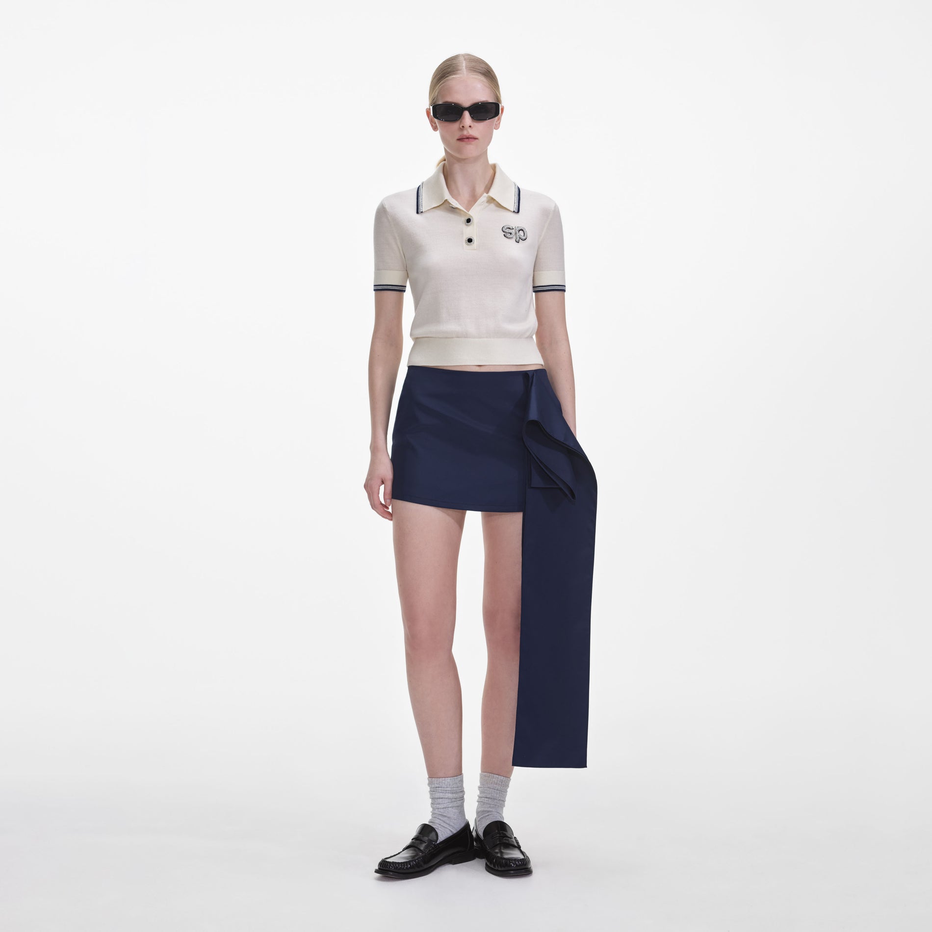 Front view of a woman wearing the Navy Nylon Mini Skirt