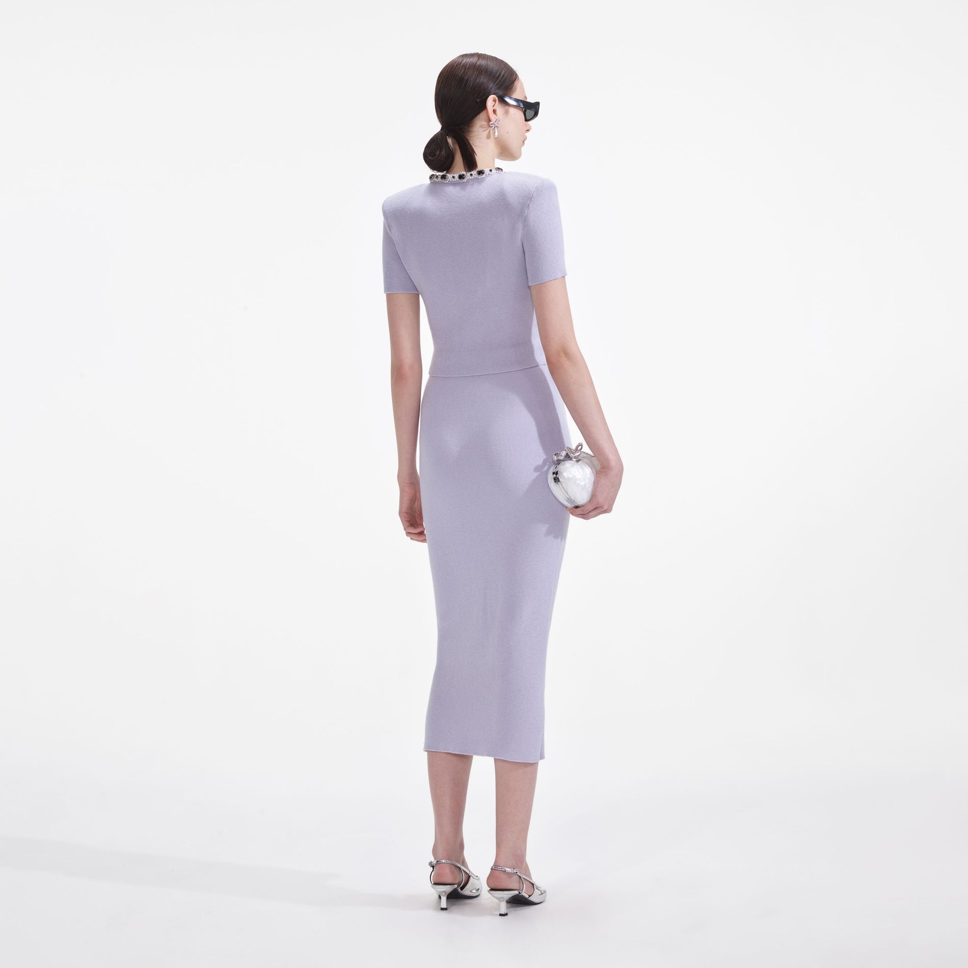 Back view of a woman wearing the Lilac Embellished Knit Top