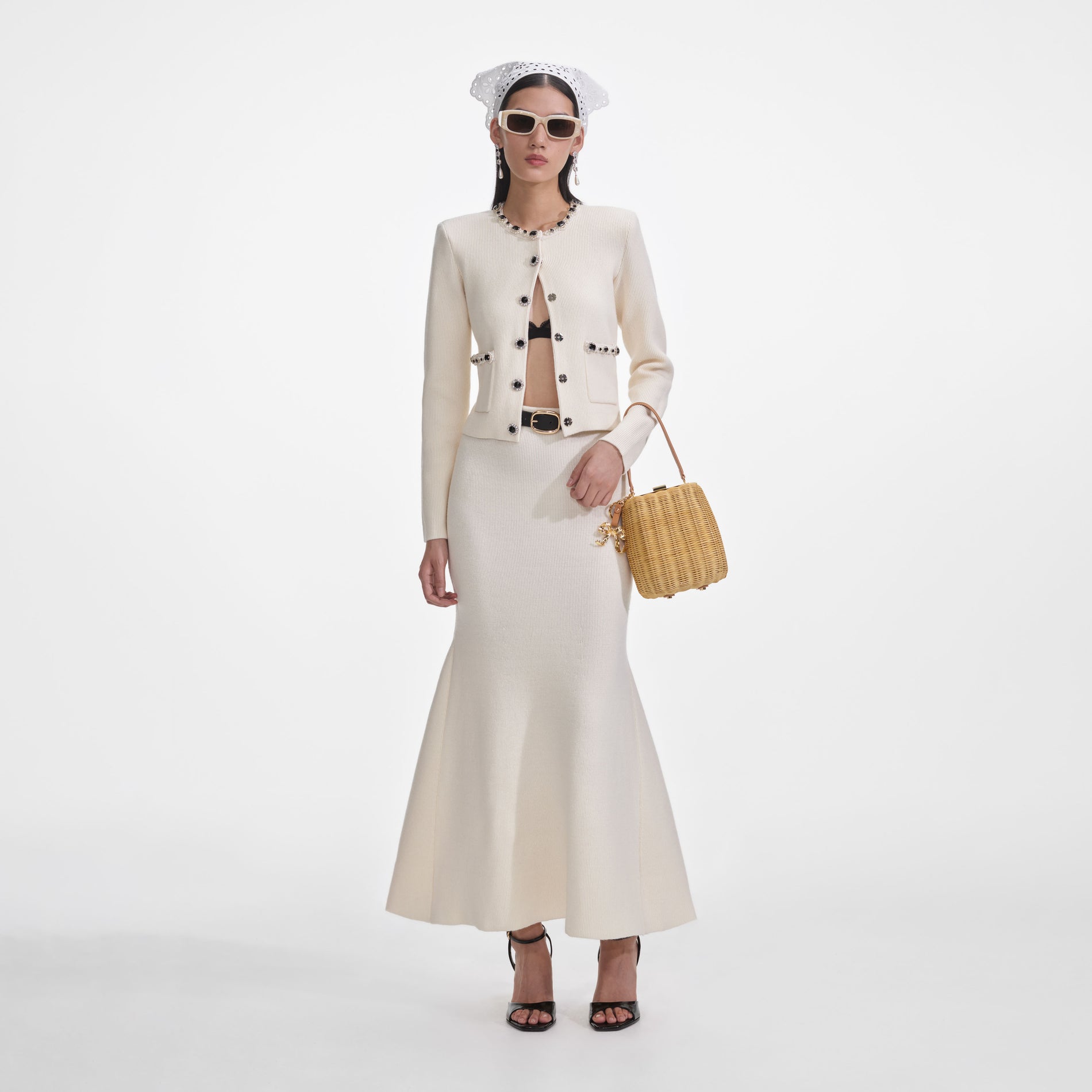 Front view of a woman wearing the Cream Flared Knit Midi Skirt