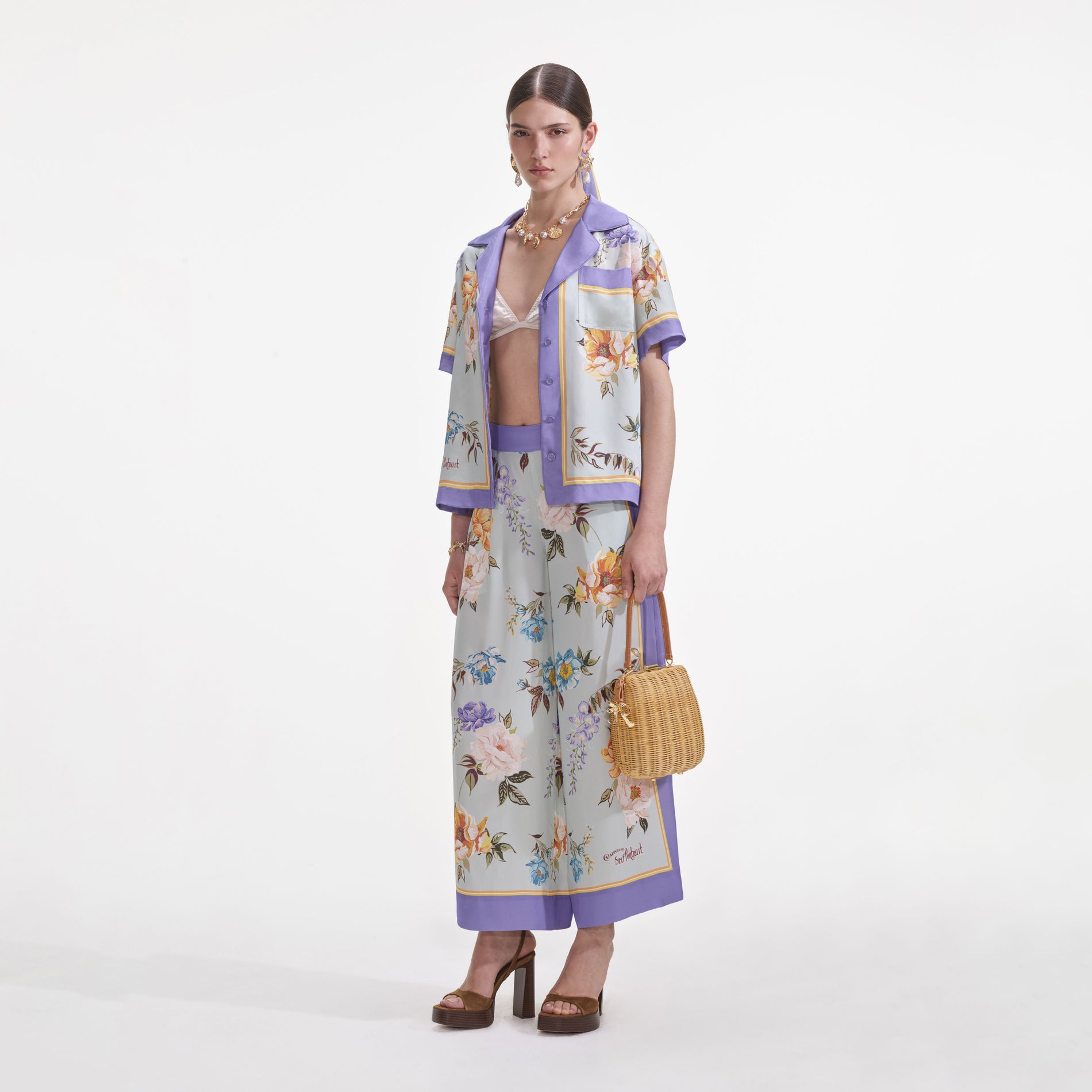 Side view of a woman wearing the Blue Floral Viscose Trousers