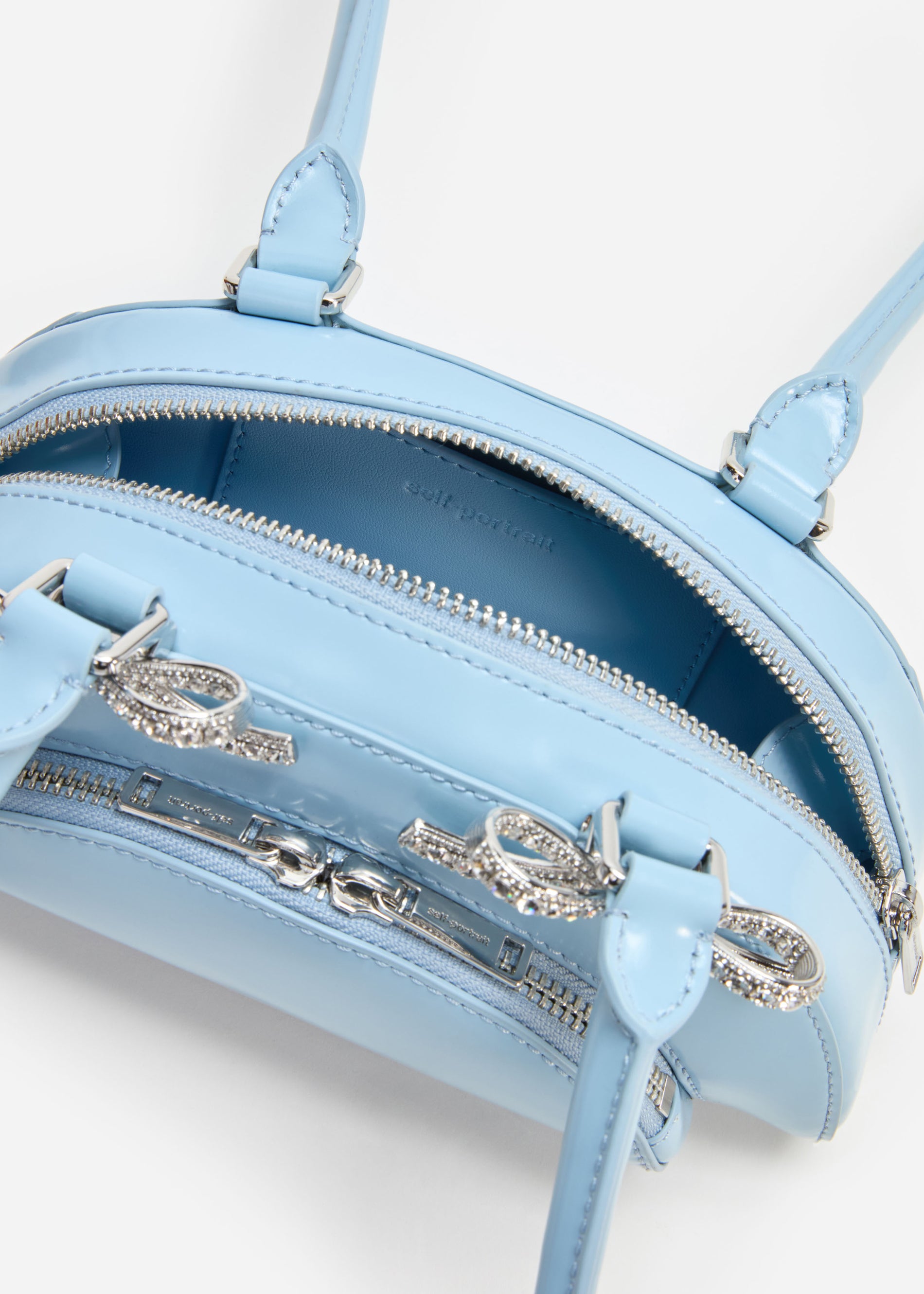 A photo of the Blue Leather Curved Mini Shoulder Bag