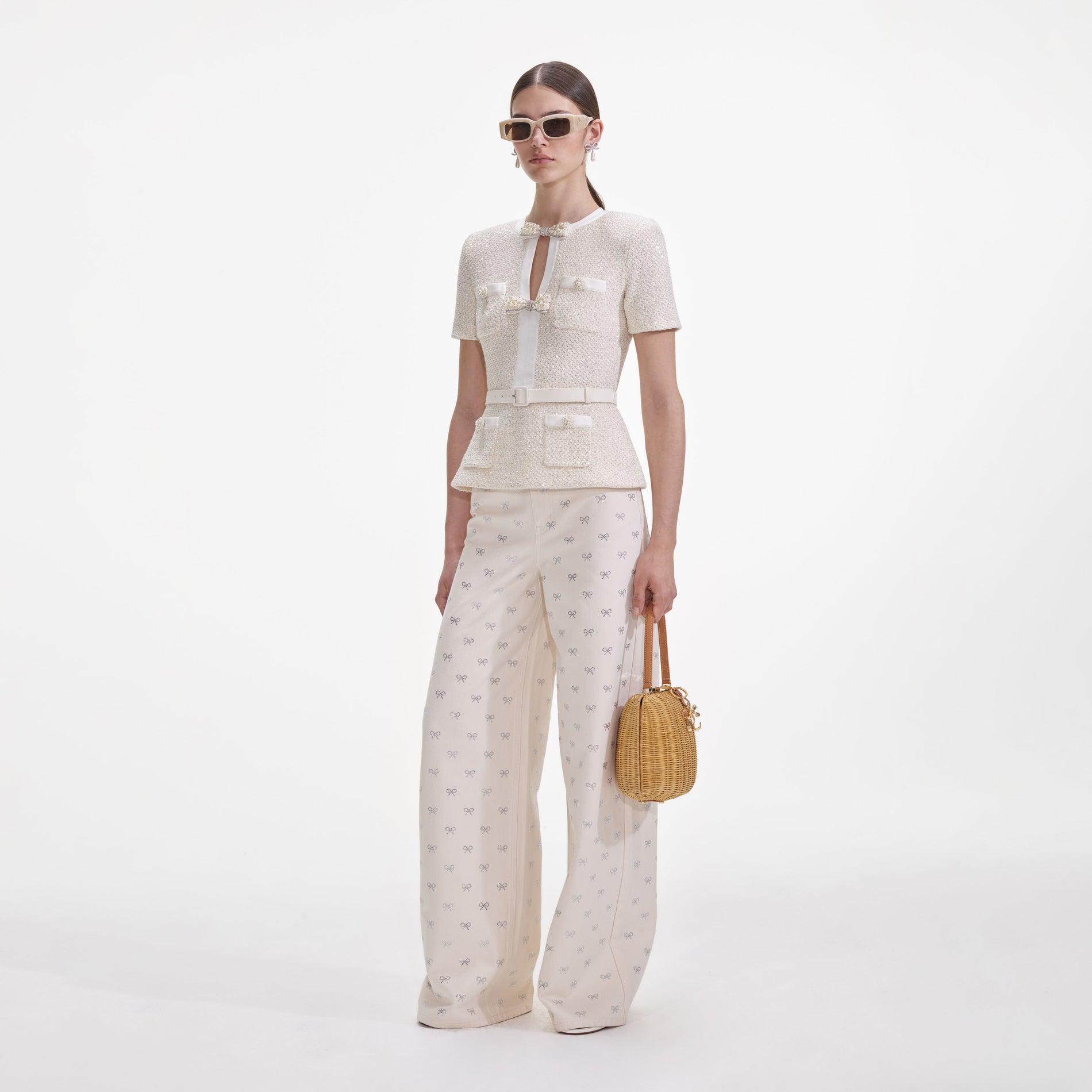 Side view of a woman wearing the Cream Sequin Knit Top