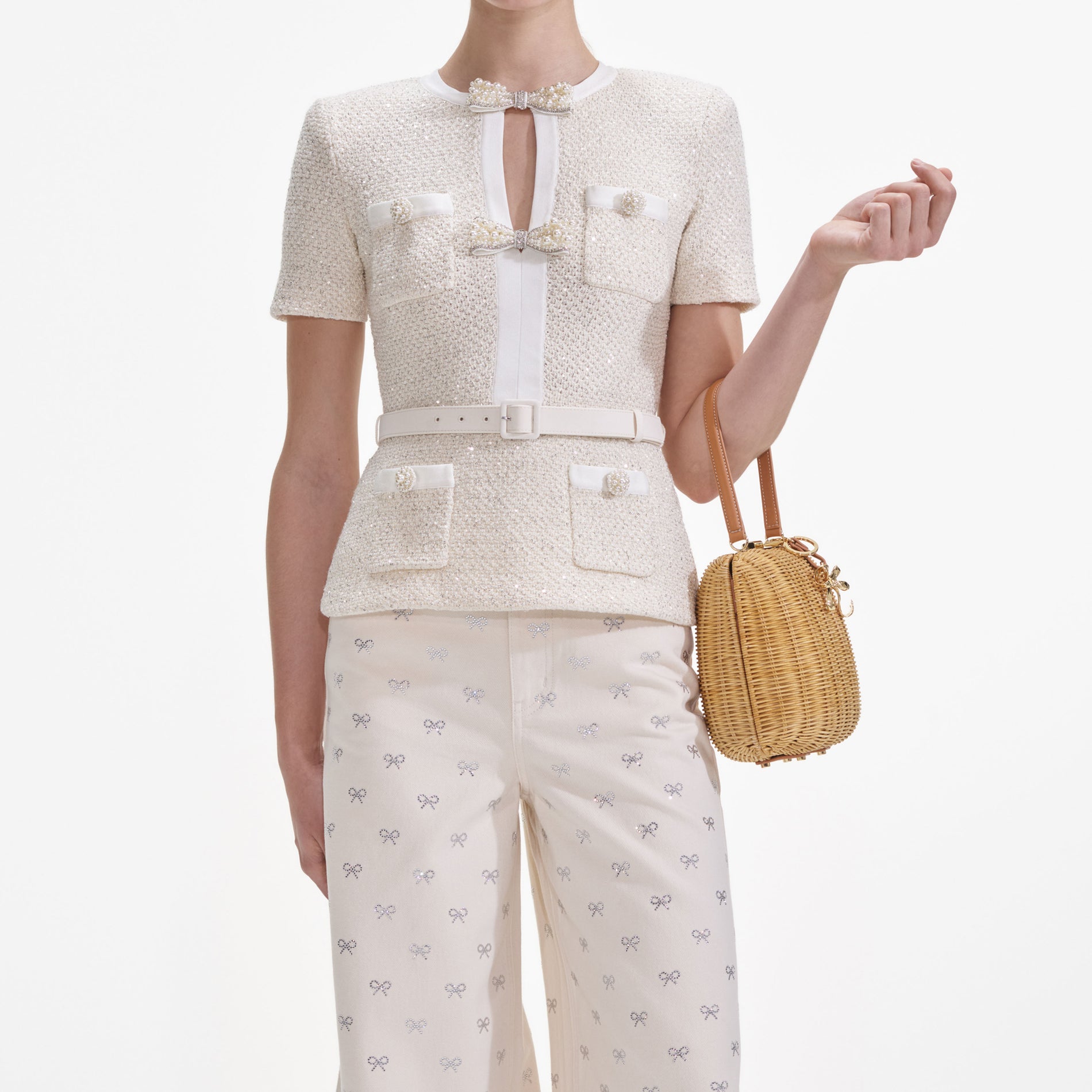 A close up of a woman wearing the Cream Sequin Knit Top