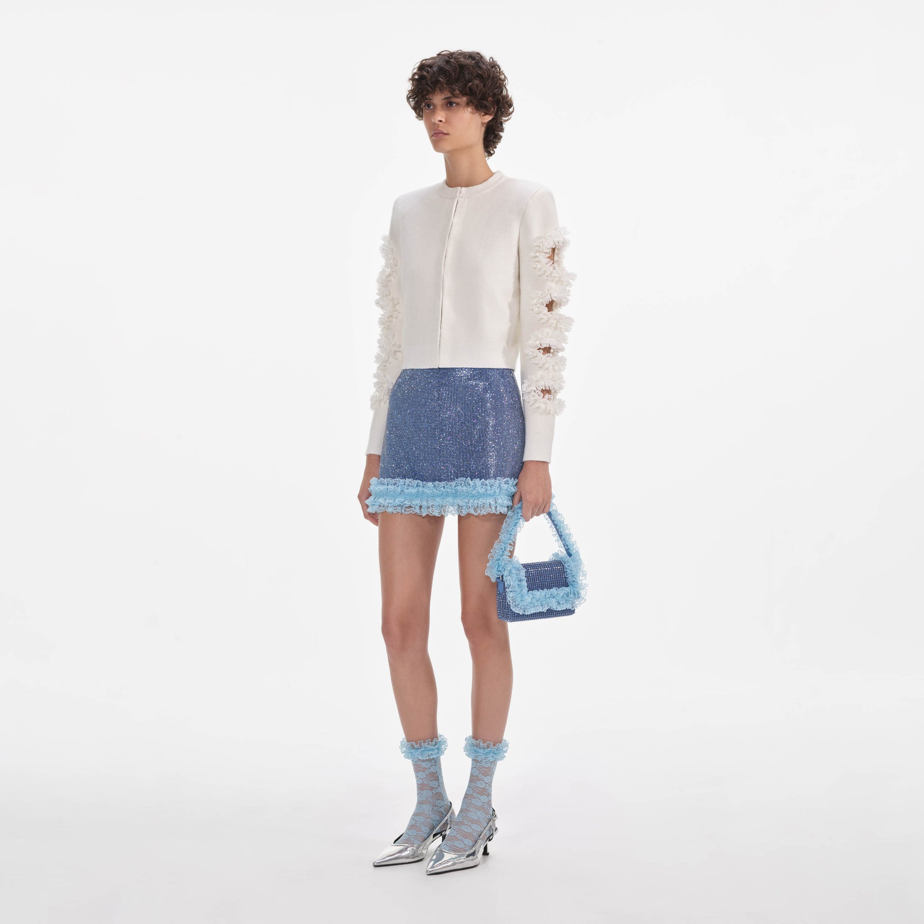 Side view of a woman wearing the White Cut Out Lace Detail Cardigan