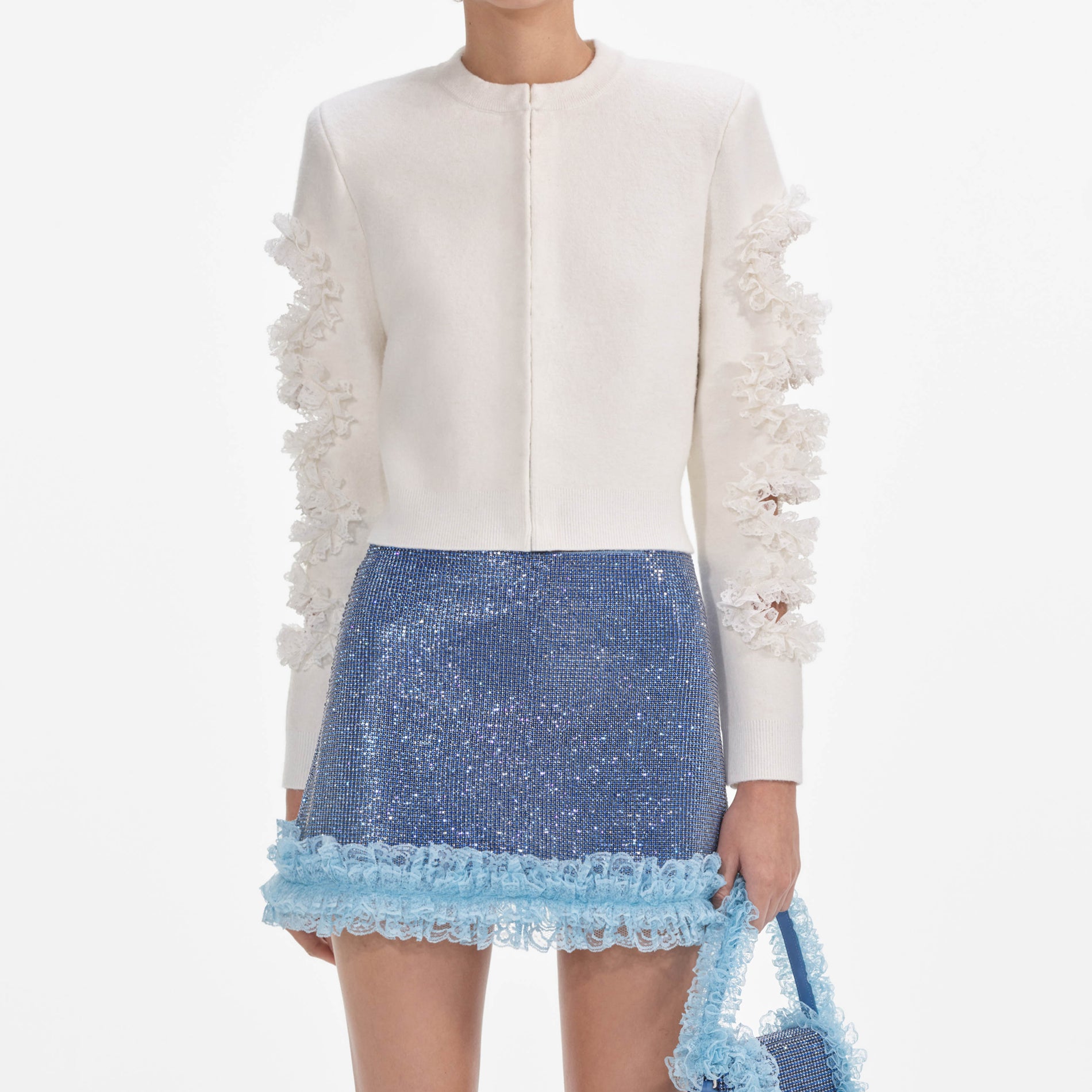 A close up of a woman wearing the Blue Crystal Chainmail Mini Skirt