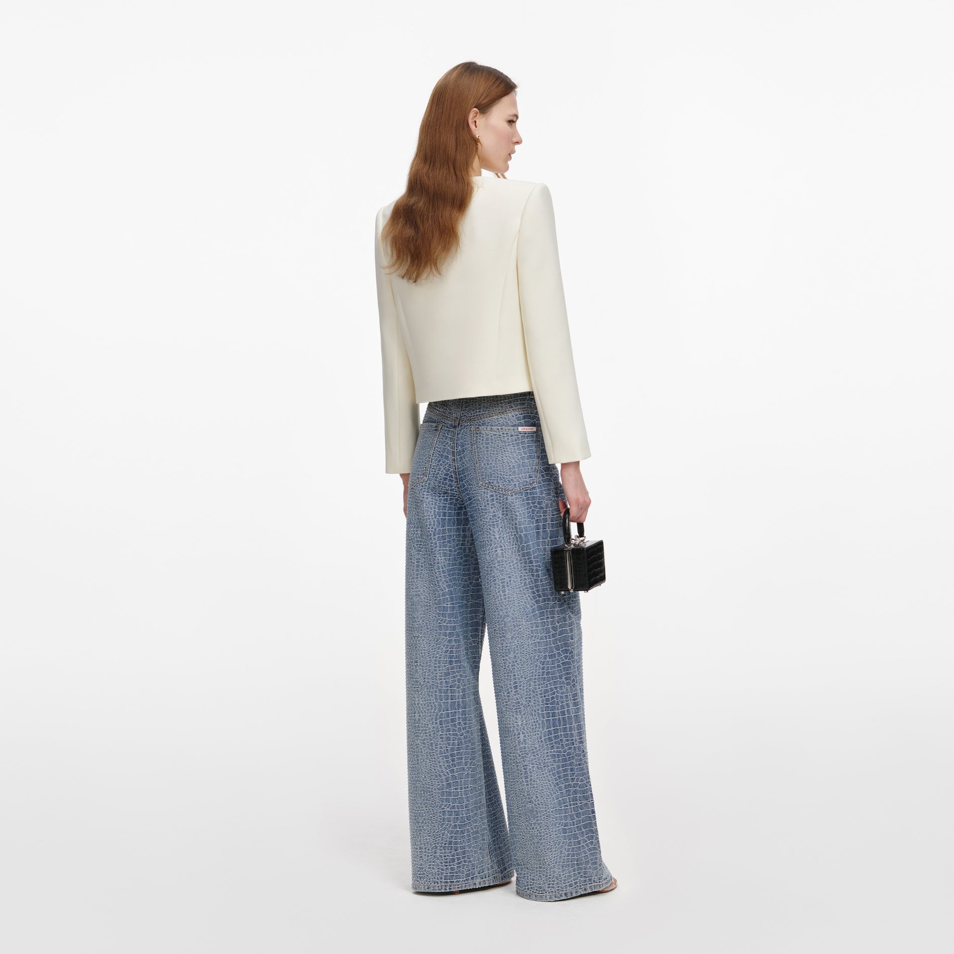 Back view of a woman wearing the Cream 3D Flower Jacket