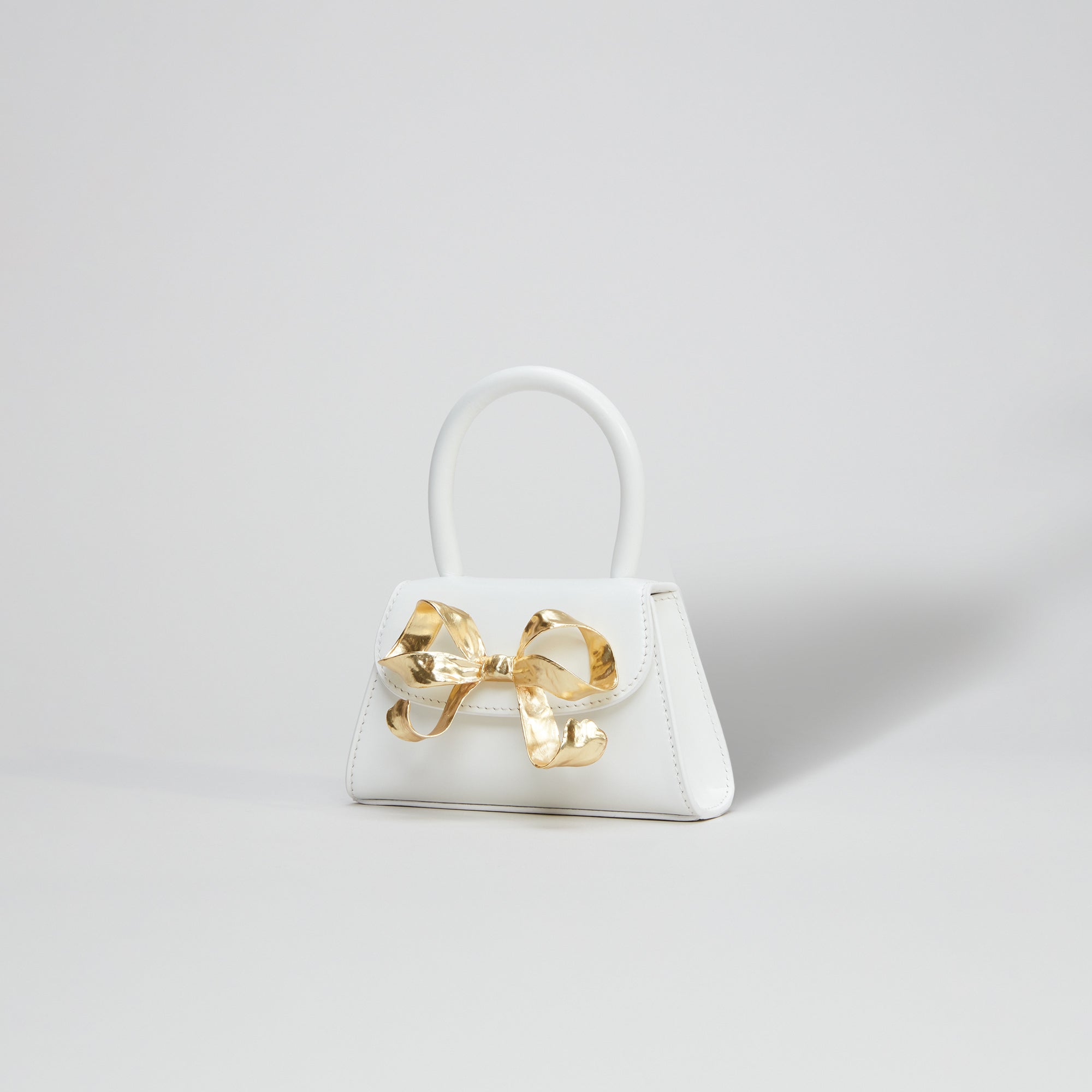 The Bow Micro in White with Gold Hardware